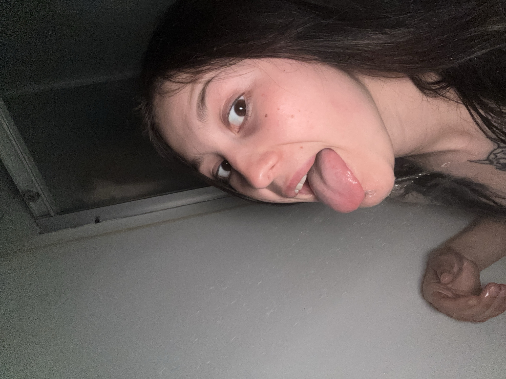 Woman makes playful gesture in bathroom, Foki Russia