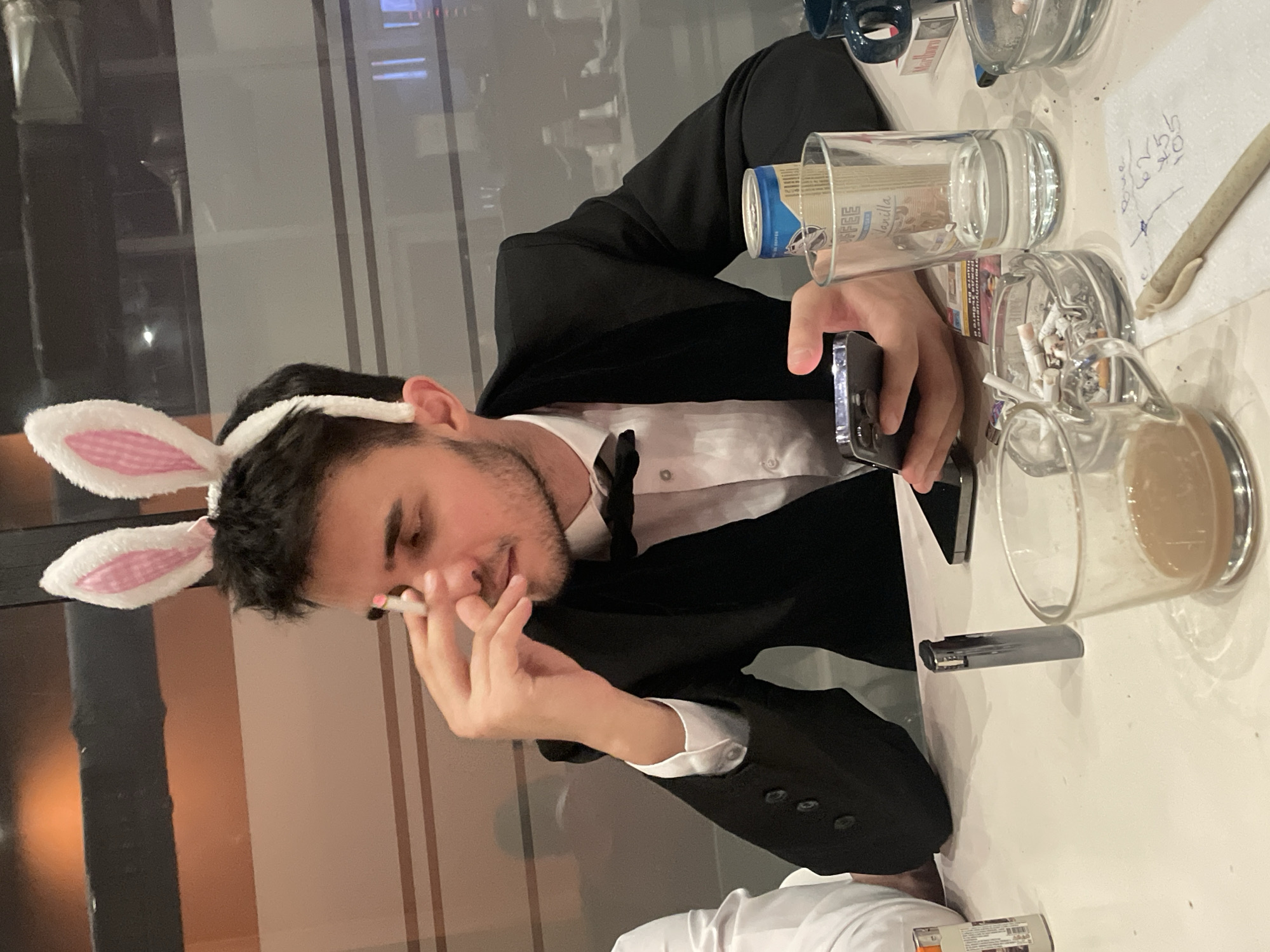 Man in black suit observed at indoor table in Sofia