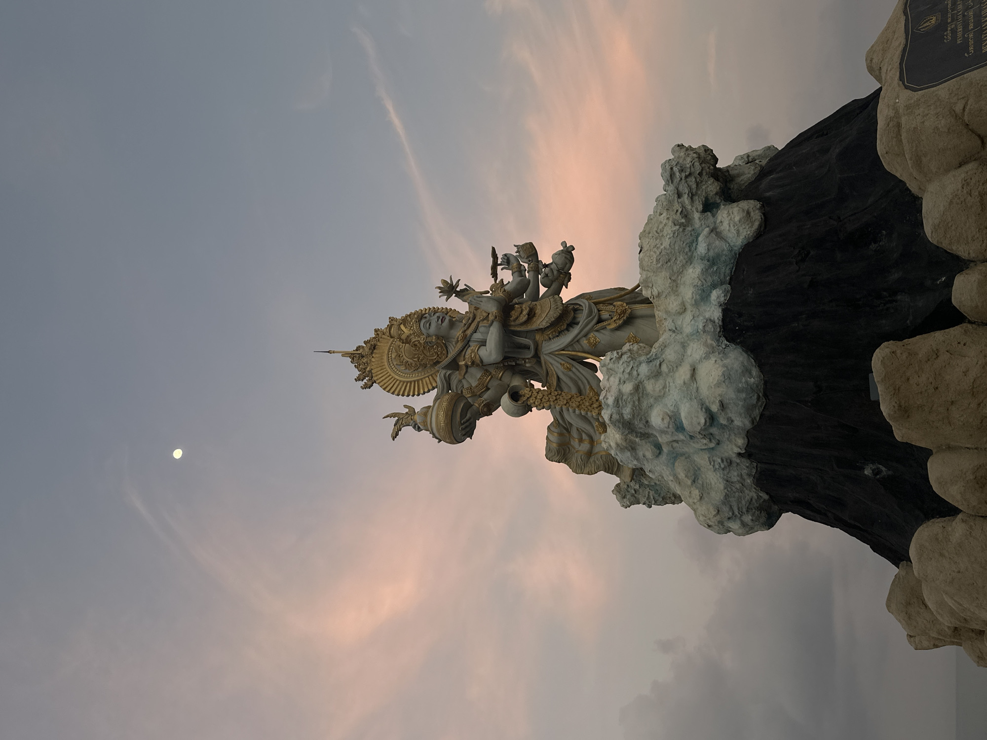 White and gold multi-armed Hindu deity statue in North Kuta