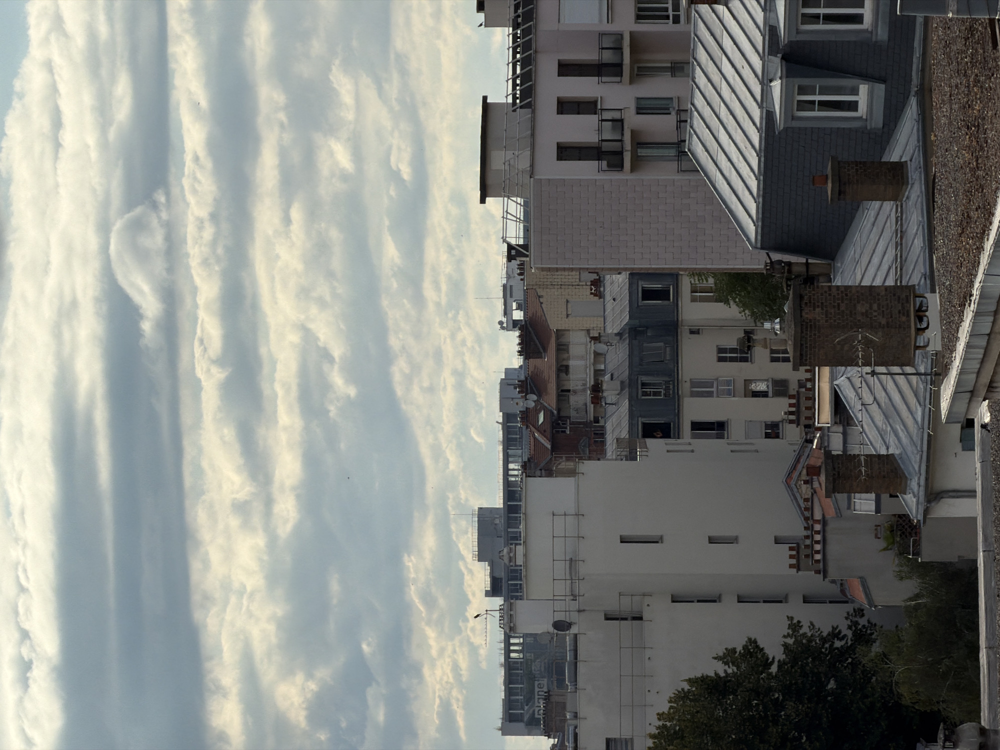 Rooftop views across Paris under a dramatic summer sky