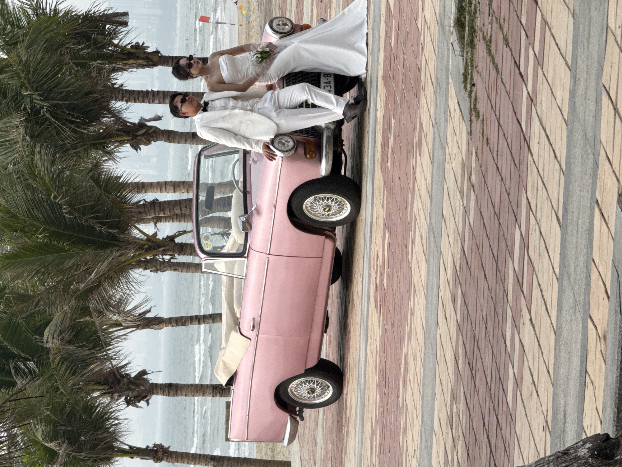 Wedding photoshoot with vintage pink car on Đà Nẵng beachfront