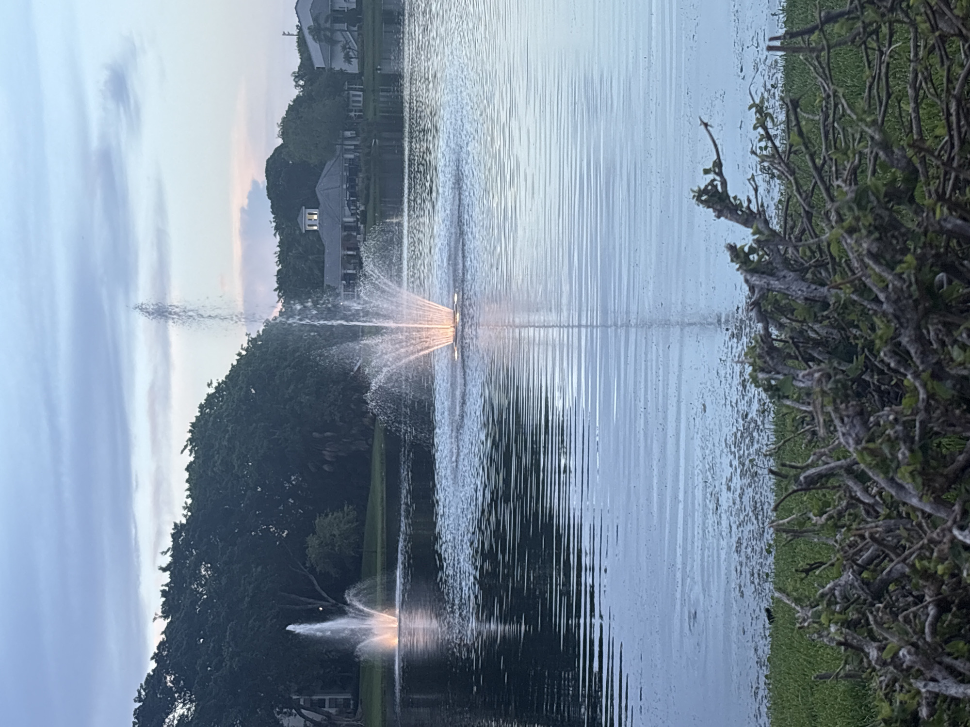 Dusk settles over a fountain lake in Delray Beach