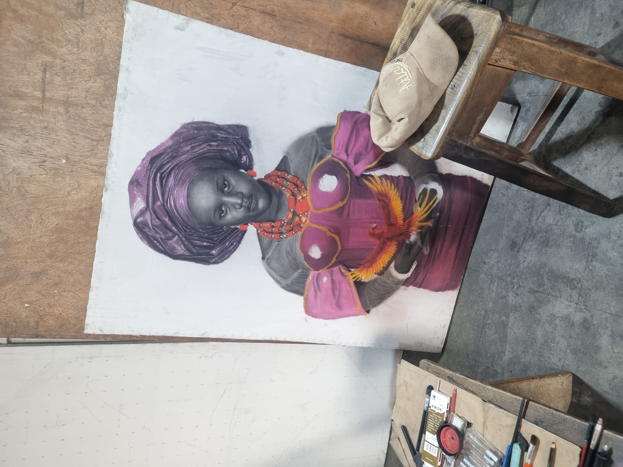 Artist works on portrait while observer watches painting session
