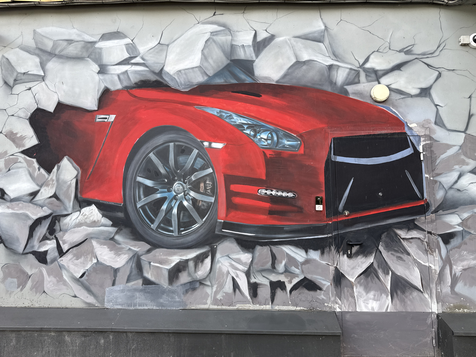 Street art mural features emerging sports car in Saint Petersburg
