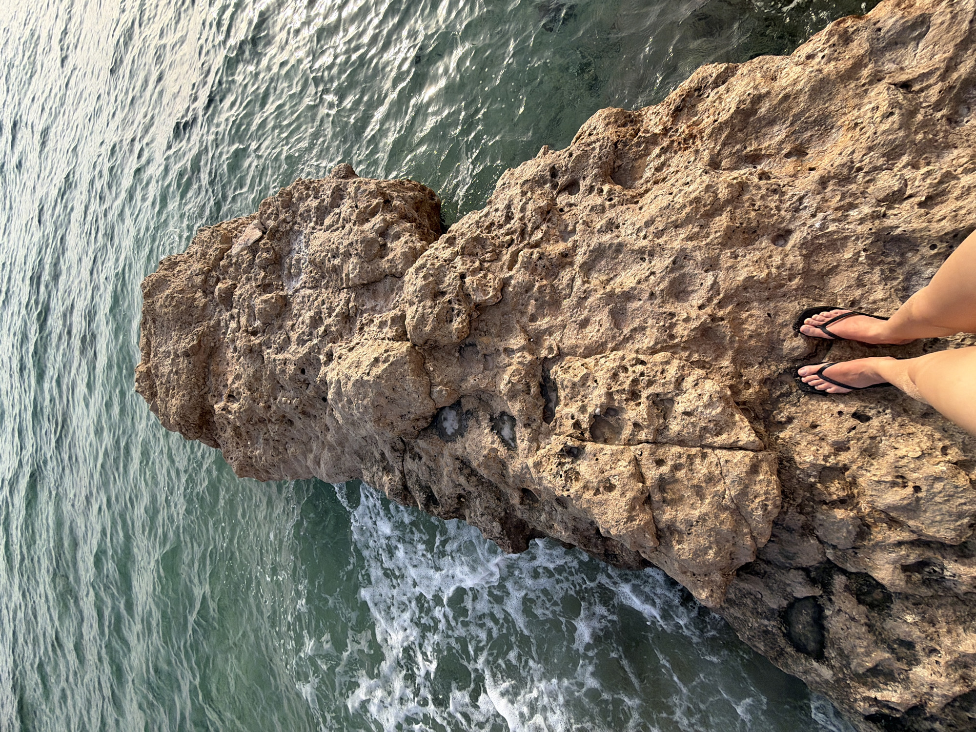 Visitor explores rocky coastline formations in Sharm El Sheikh