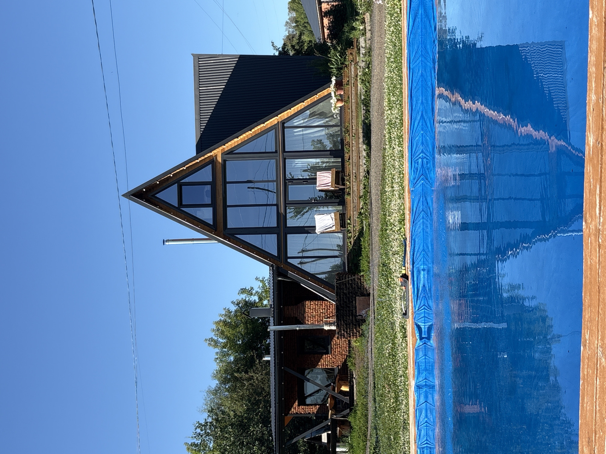 Summer group gathering at a lakeside A-frame in Zav'yalovo