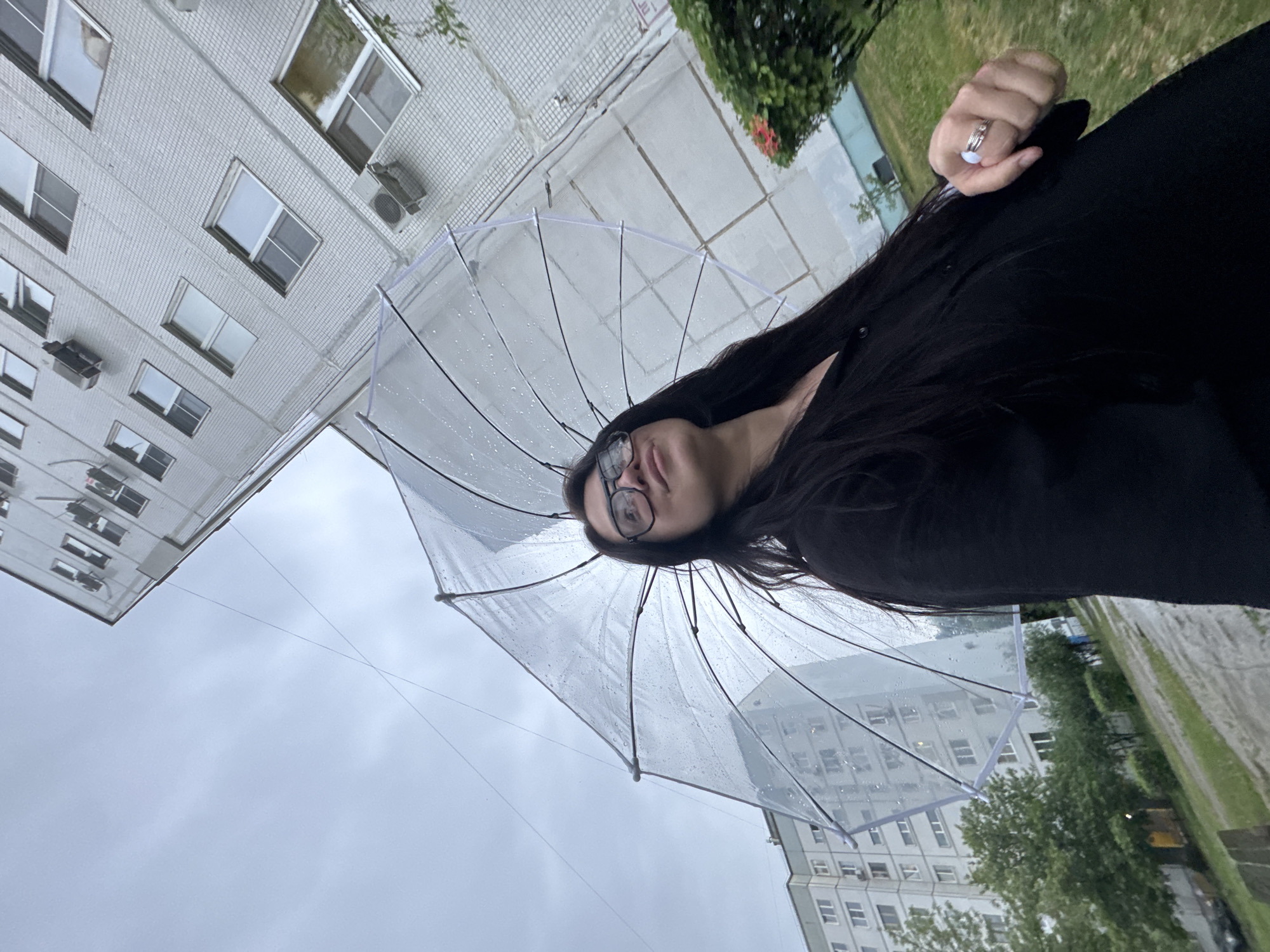 Woman photographed multiple times during cloudy afternoon in urban setting