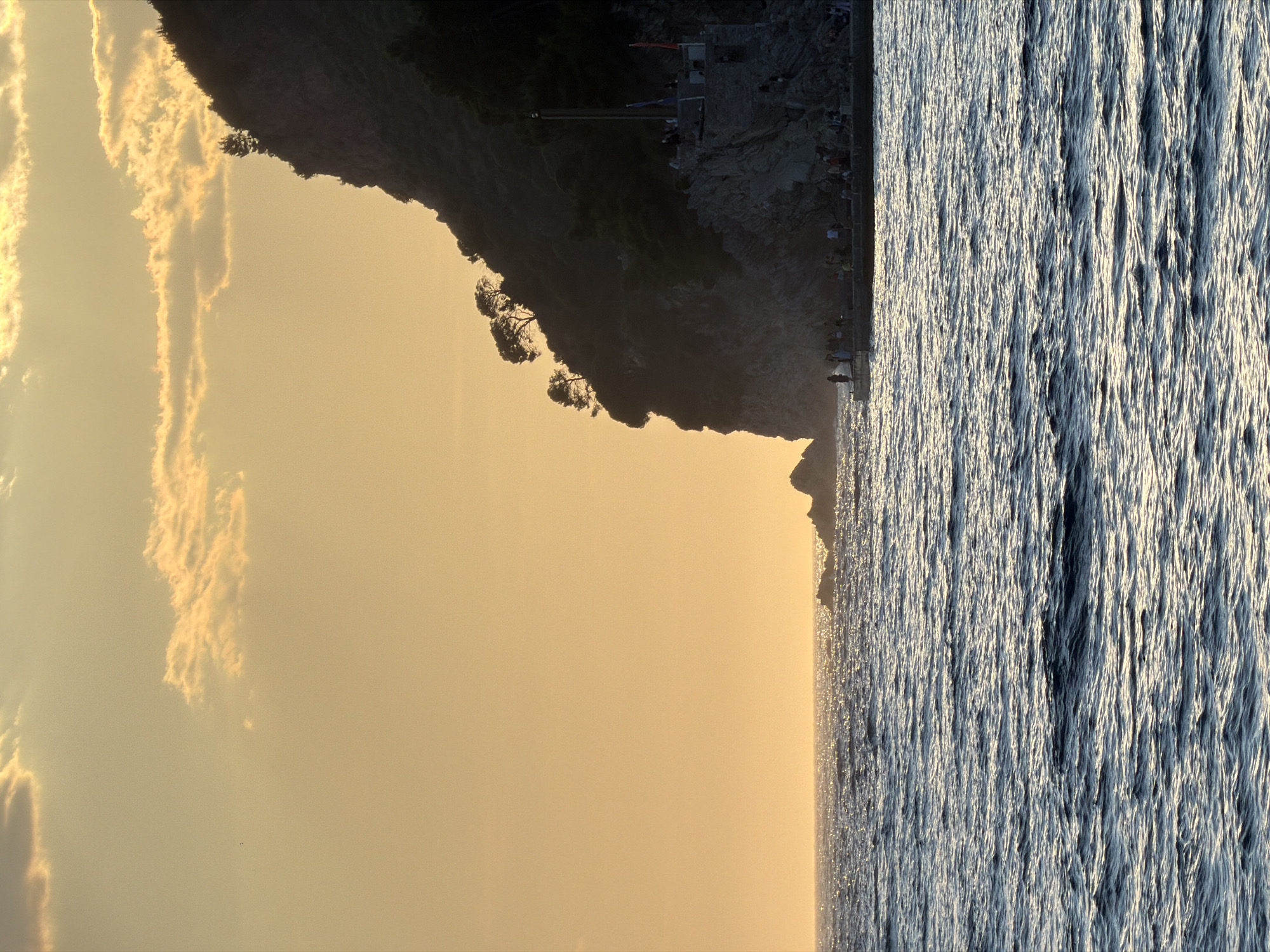 Sunset over rocky cliffs in Petrovac, Montenegro