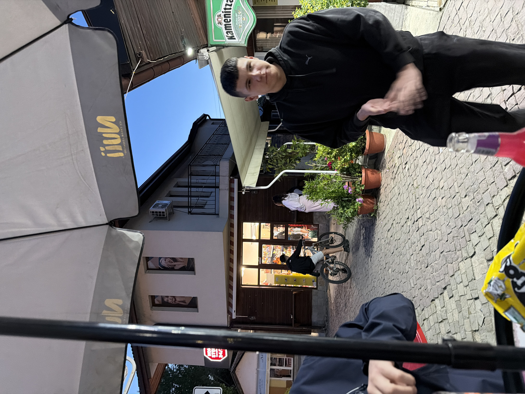 Evening cafe culture captured on Panagyurishte cobblestone streets