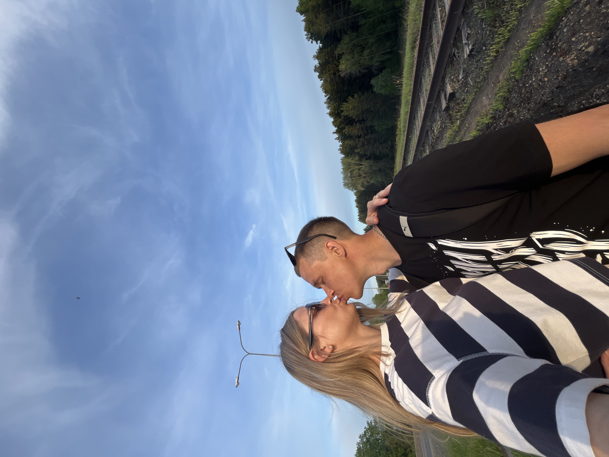 Couple stages romantic photoshoot on railway tracks in Chaikovsky