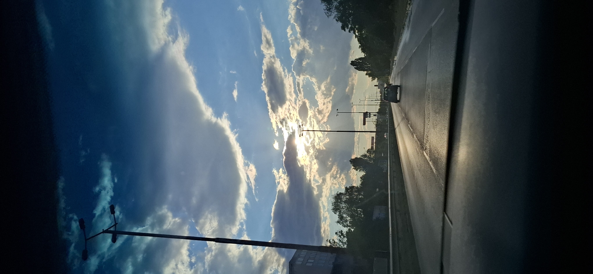 Dramatic storm-break sky over highway and construction site