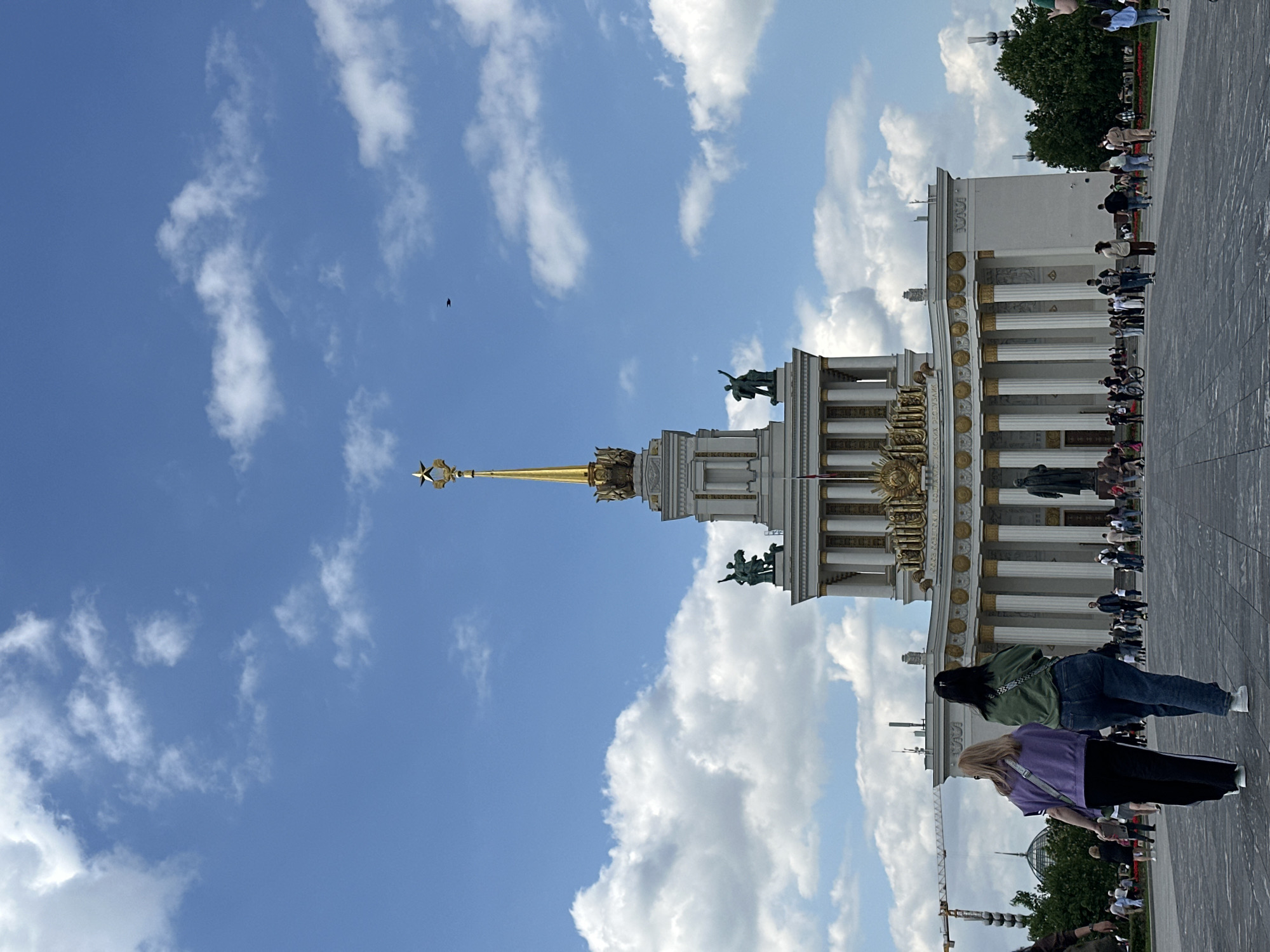 Women in red gather at Moscow's VDNKh pavilion steps