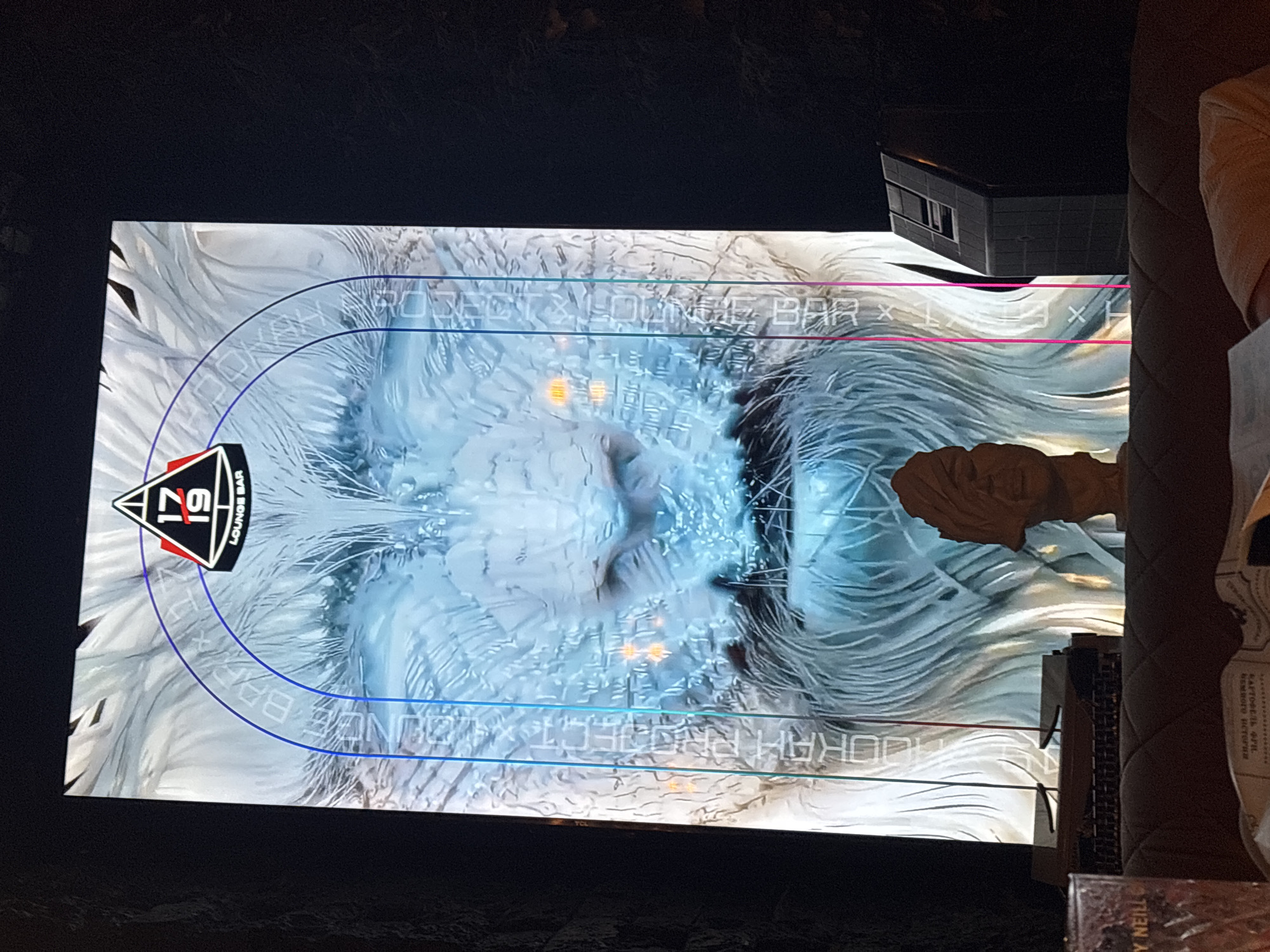 Inside Kazan's 17/19 Lounge Bar: digital art, dim lights, eclectic decor