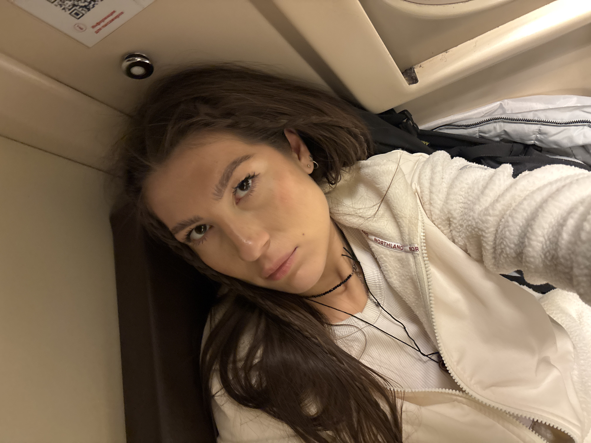 Woman photographed in train compartment during evening journey near Шемордан