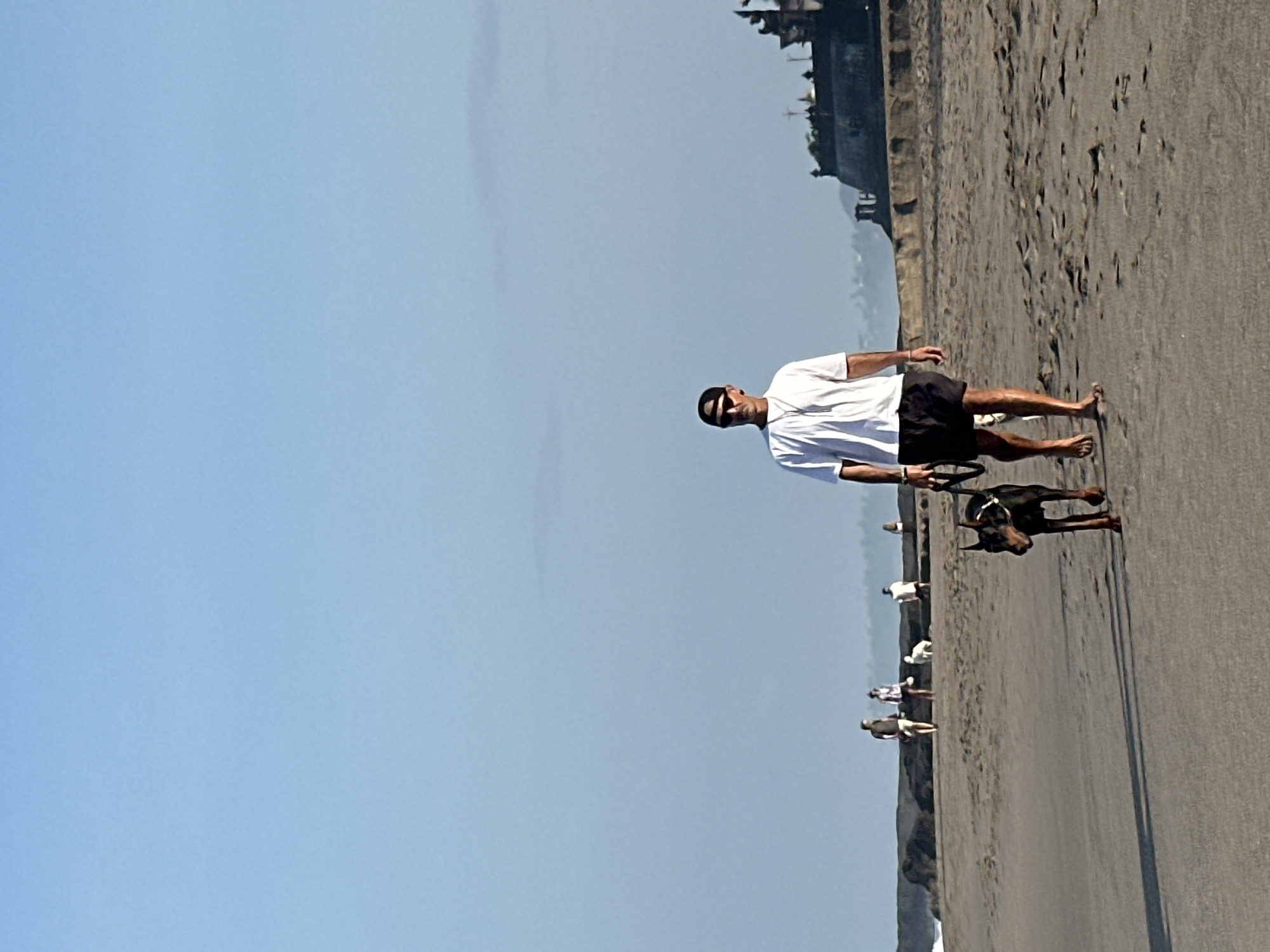 Golden hour on North Kuta beach: people, dogs, and surf.
