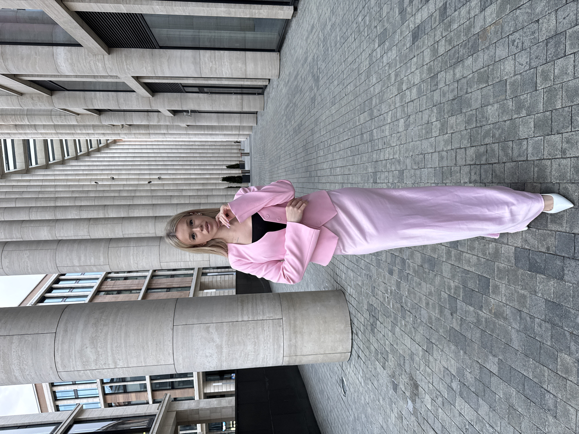 Pink suit, big columns — posing outside modern Saint Petersburg architecture