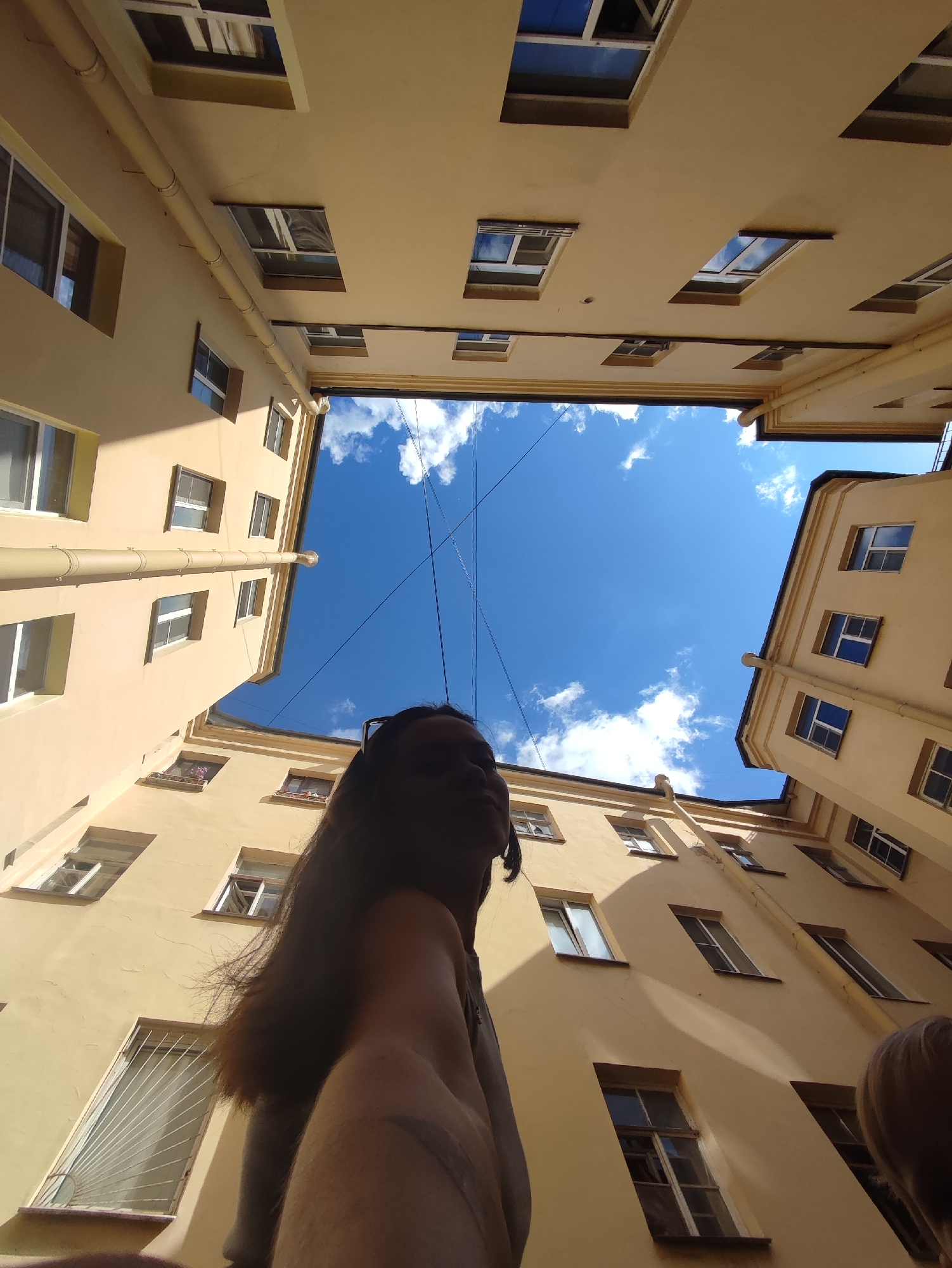 Looking up from a Saint Petersburg courtyard on a clear morning