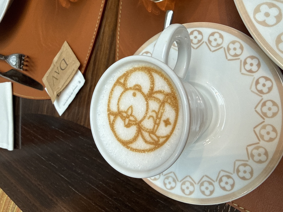 Woman enjoys coffee at luxury Hermès Caffè in Milan