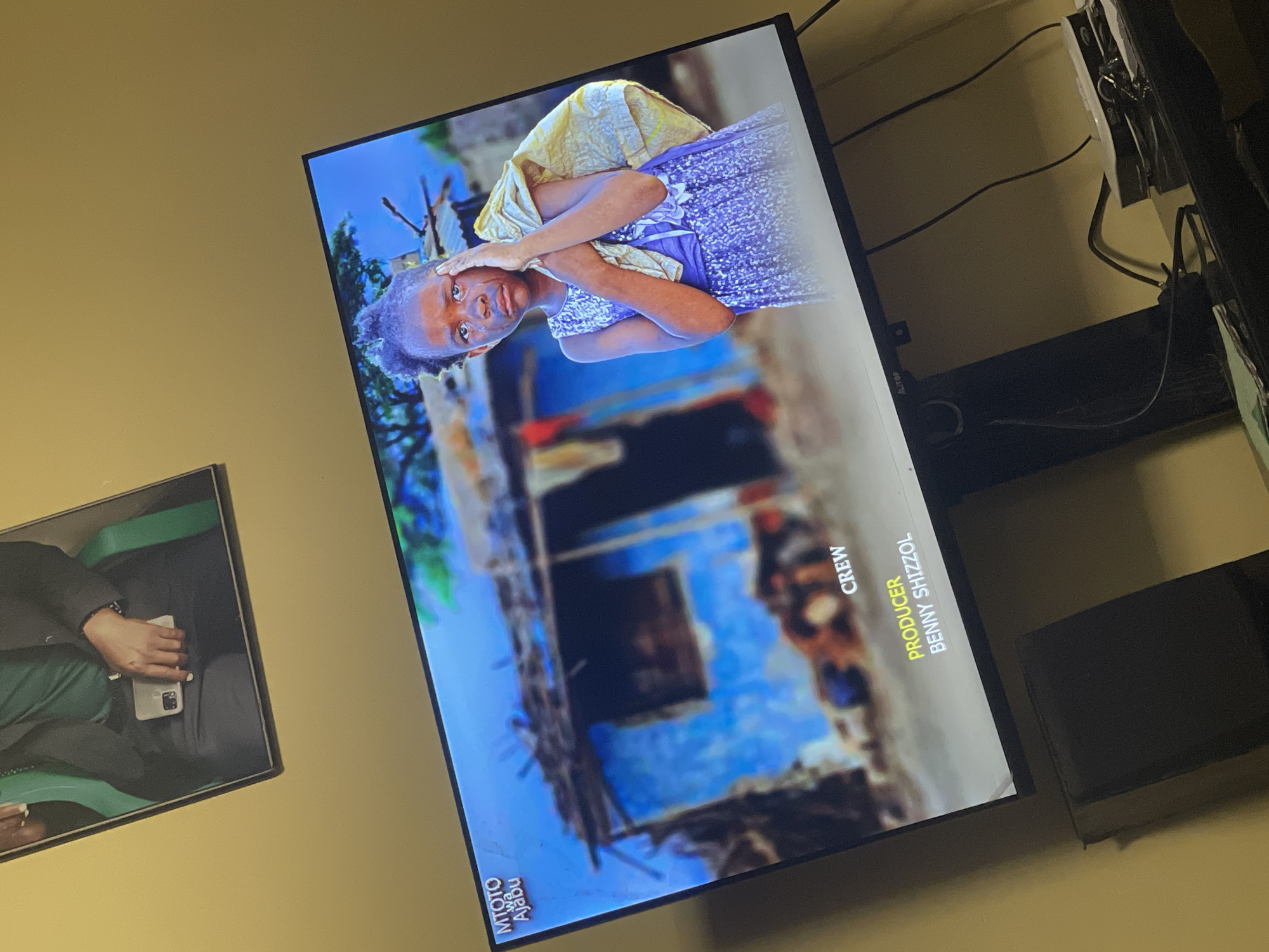 Television displays image of young girl in yellow and blue