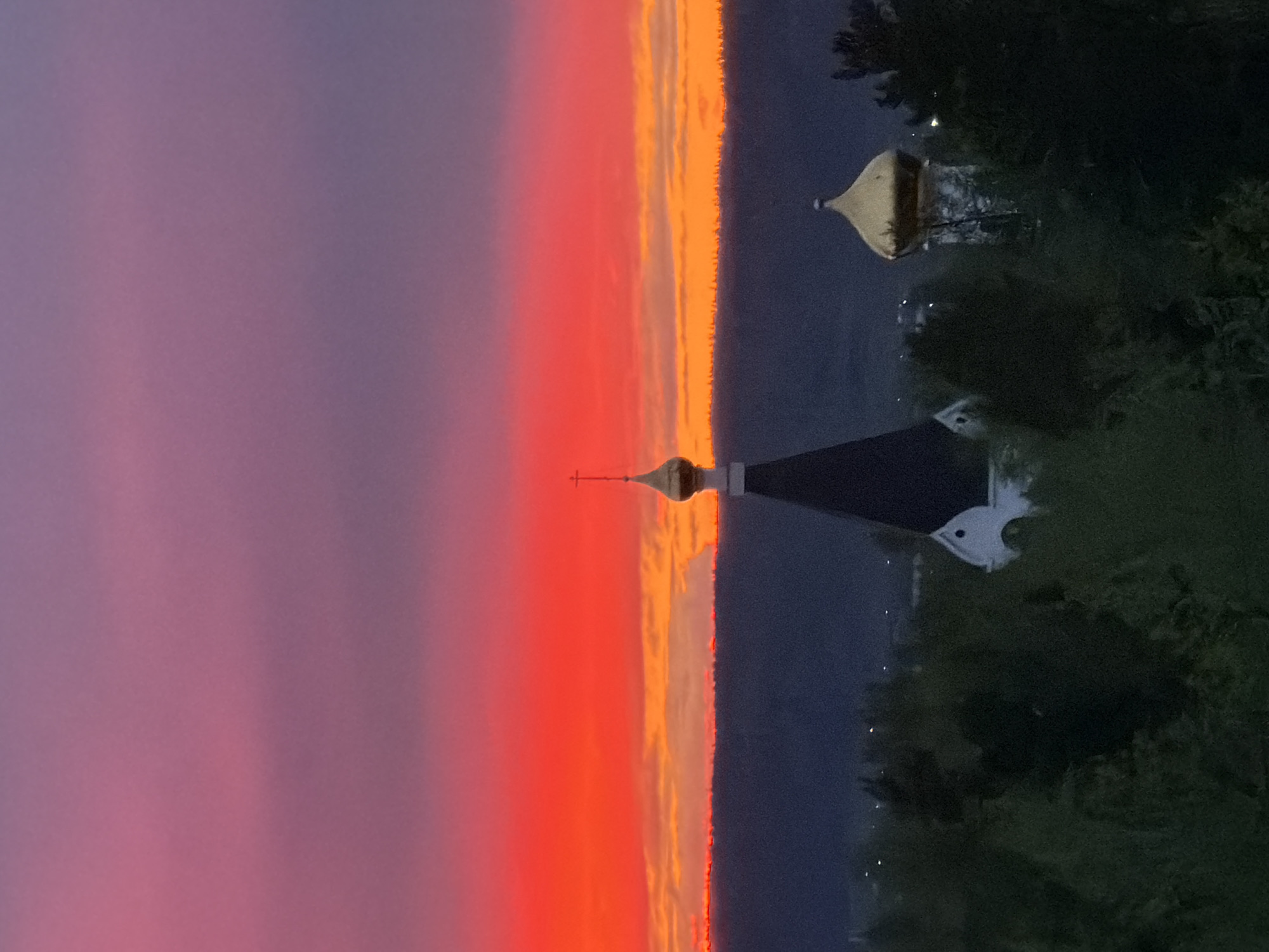 Vibrant sunset observed over church in Ust-Ilimsk, Russia