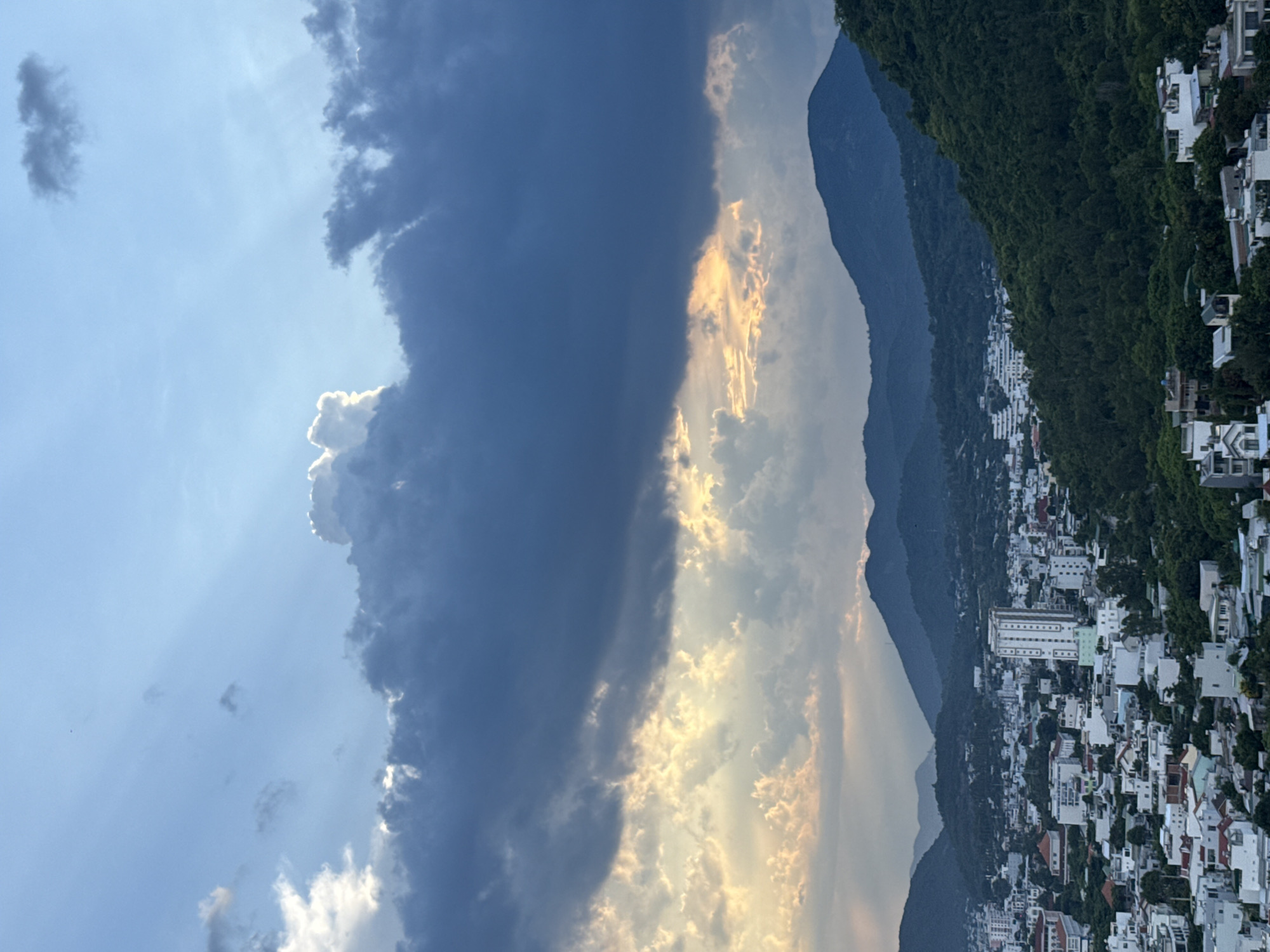 Crepuscular rays break through storm clouds over coastal Nha Trang
