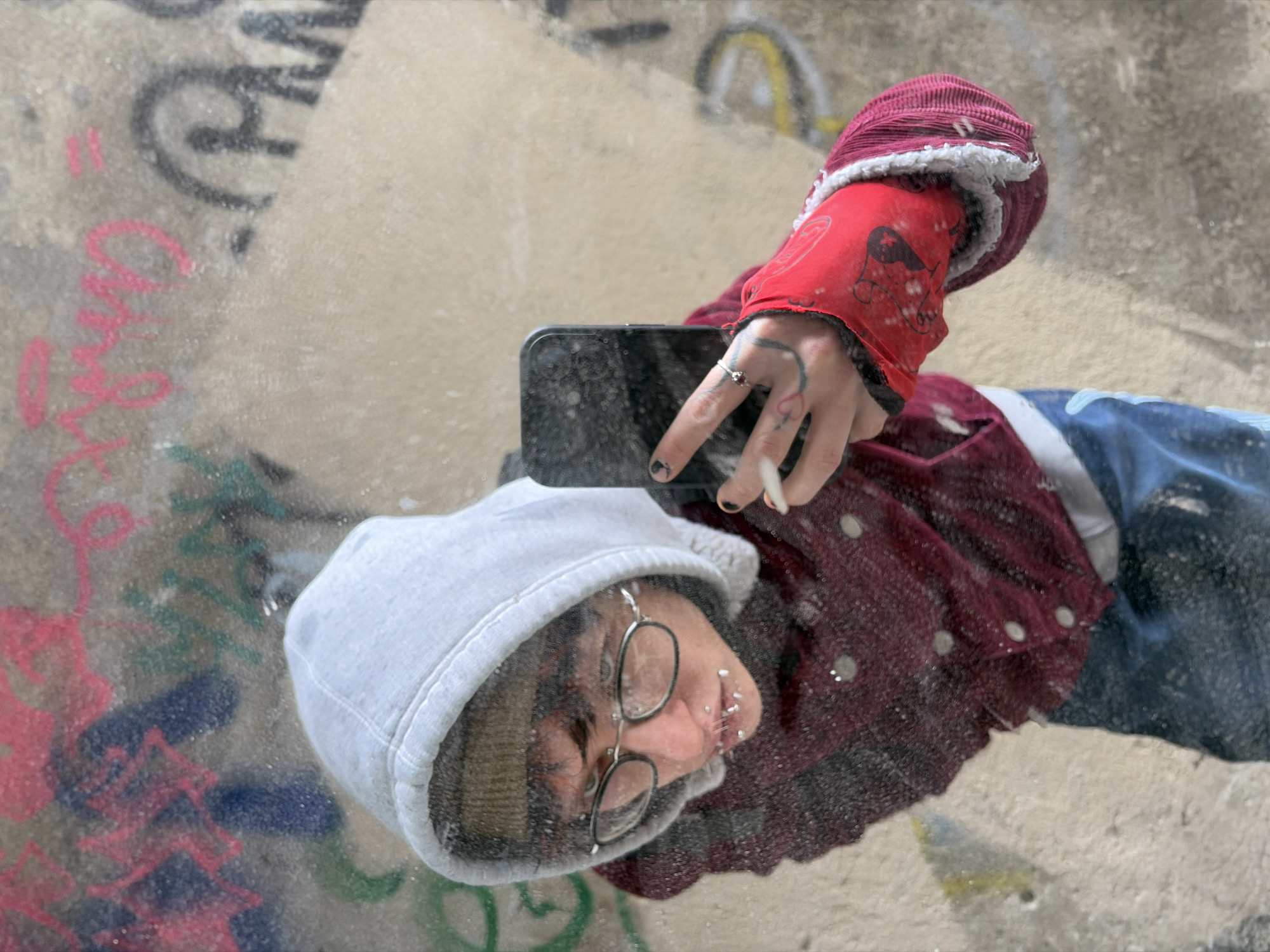 Person takes mirror selfies amid graffiti in Sofia