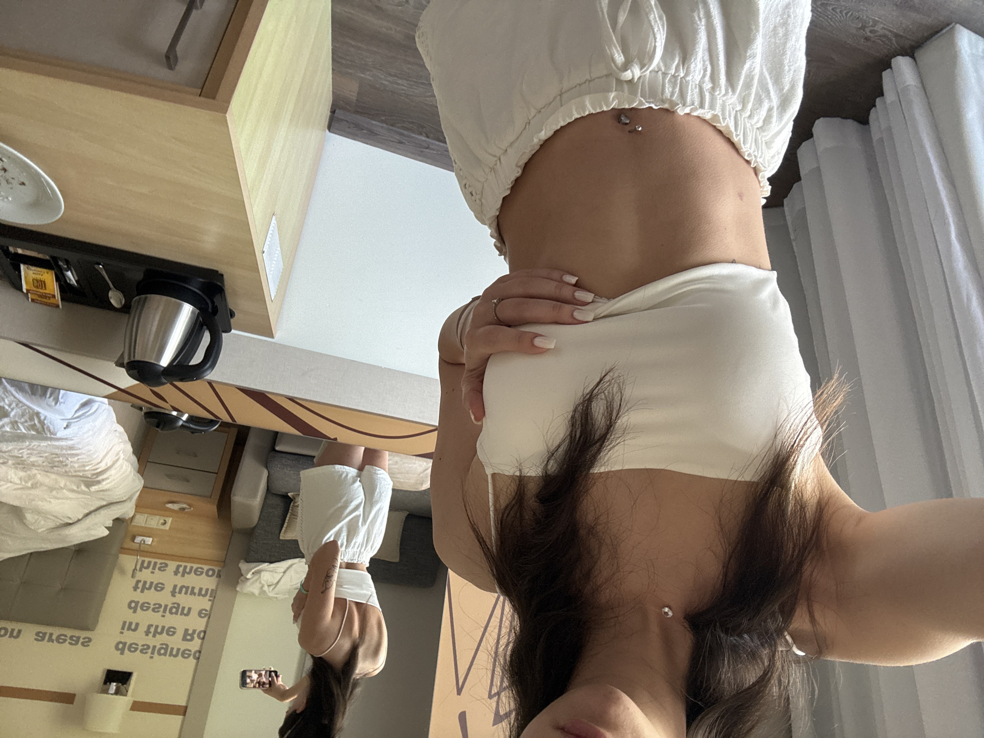 Woman documents hotel morning routine with selfies and coffee