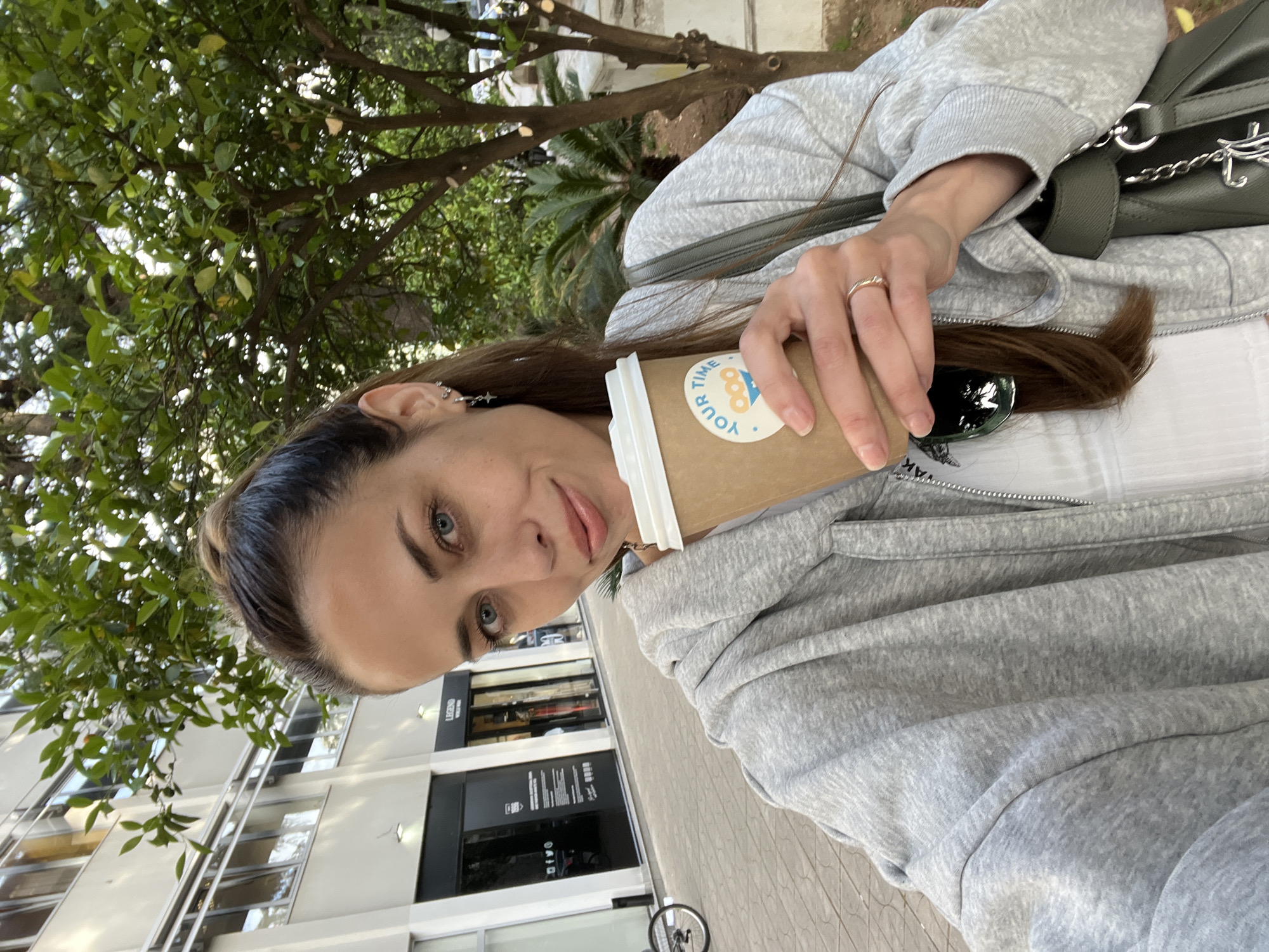 Woman with coffee spotted outside Legend building in Bar