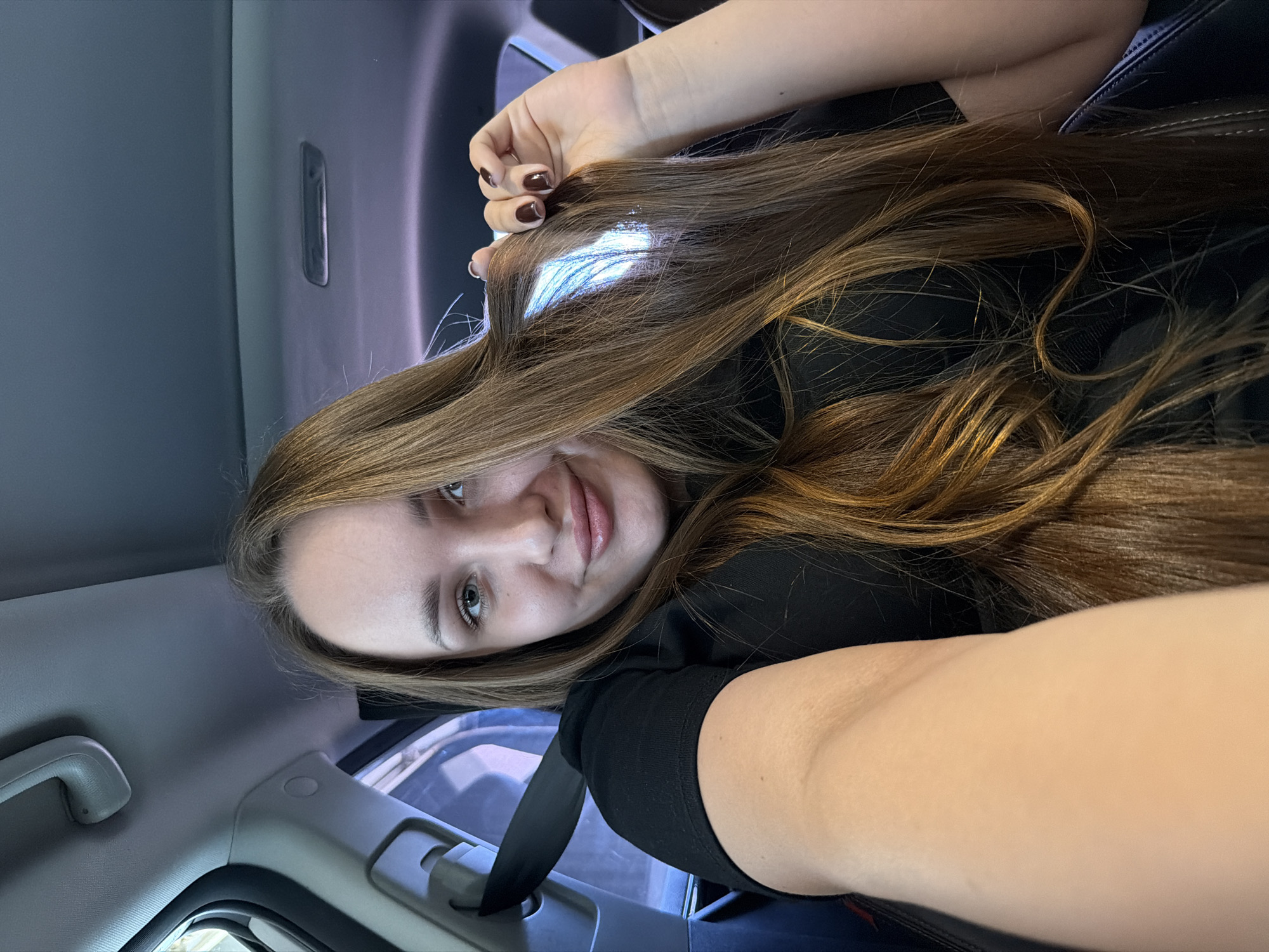 Woman films selfies during car wash in Chaikovsky, Russia