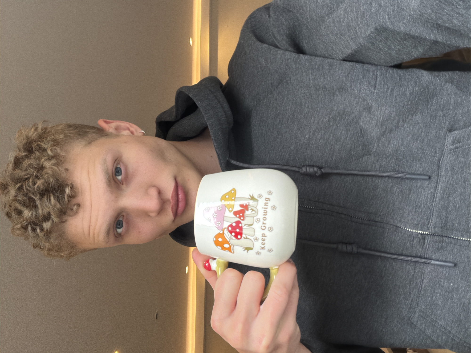 Person holds inspirational mushroom mug in London