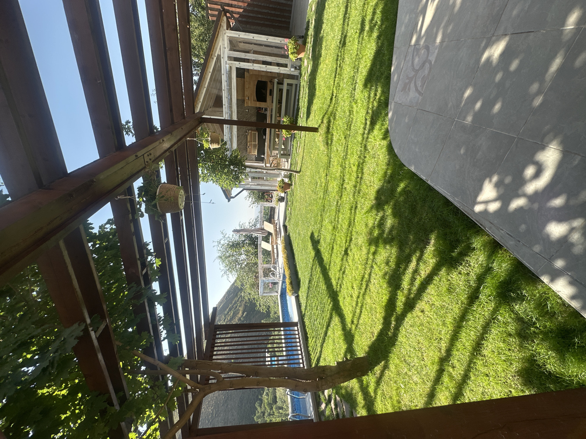 Backyard pool and pergola setup in sunny Almaty