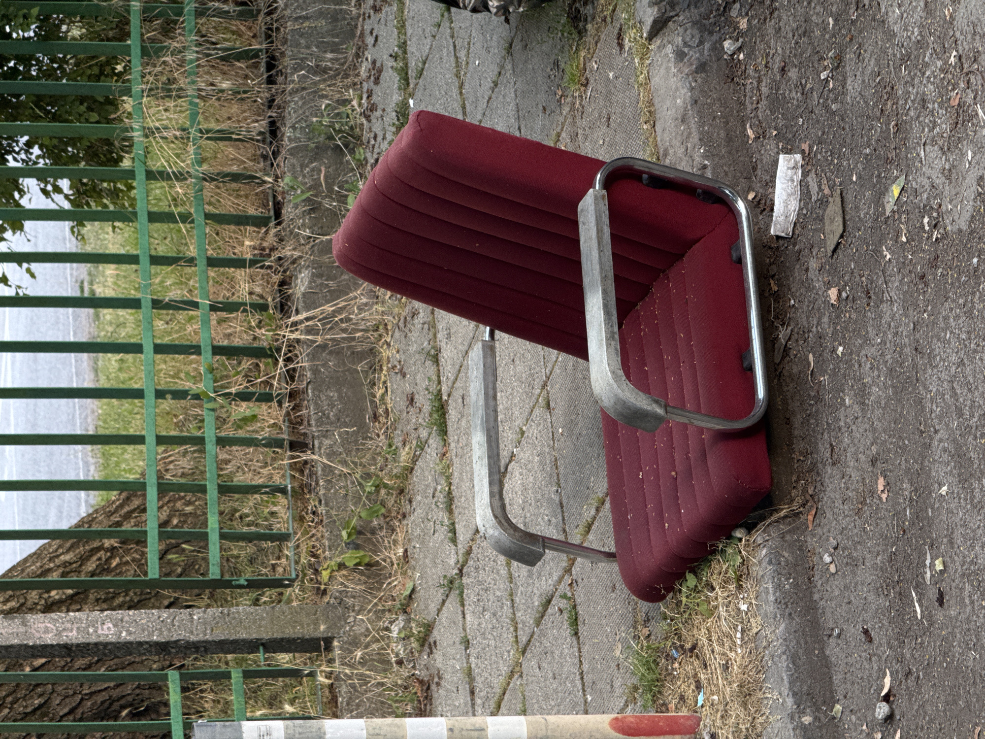 Lone red chair sitting on concrete in Sofia