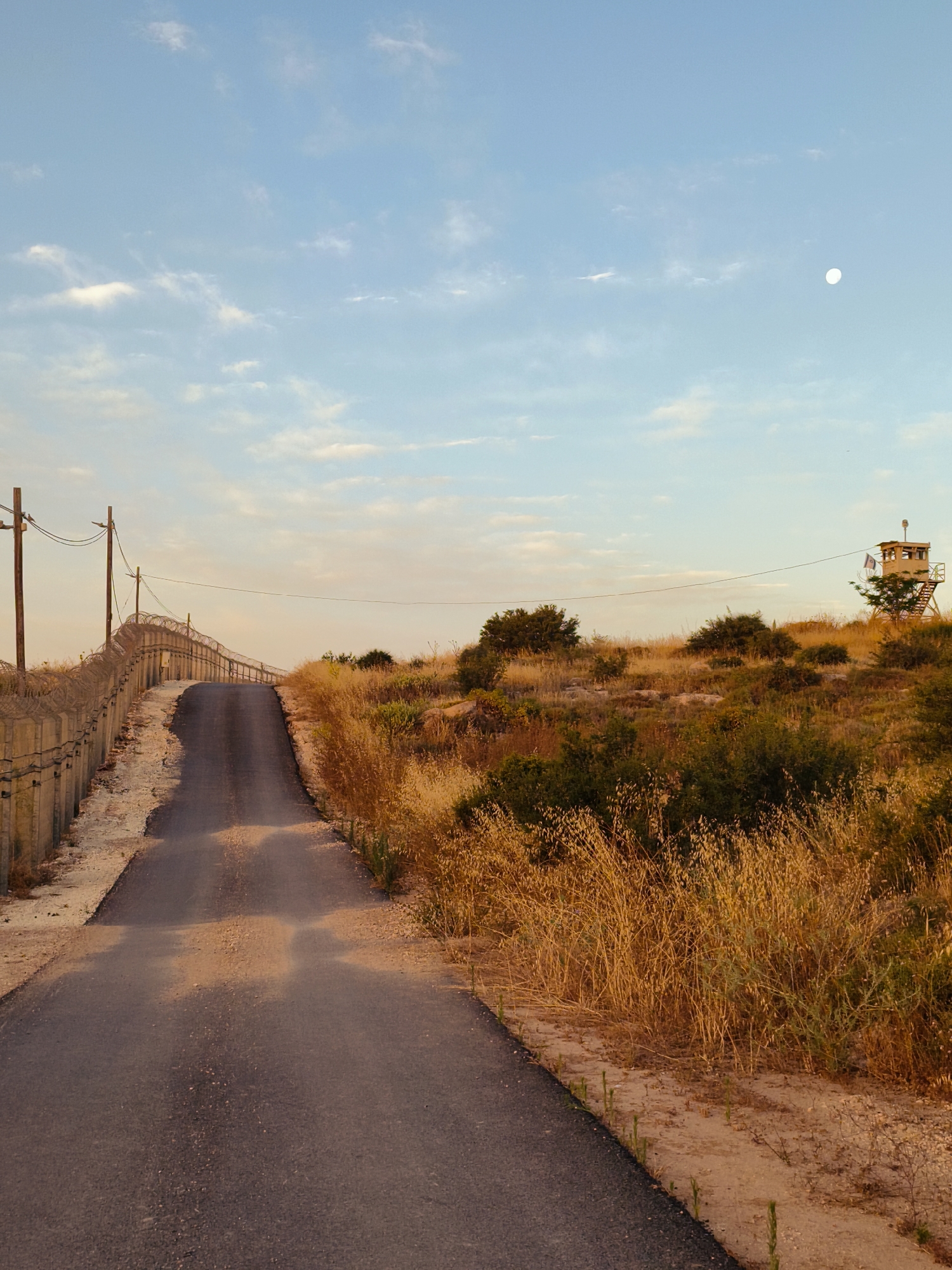 Rural sunset documentation includes security fences in Lachish Council