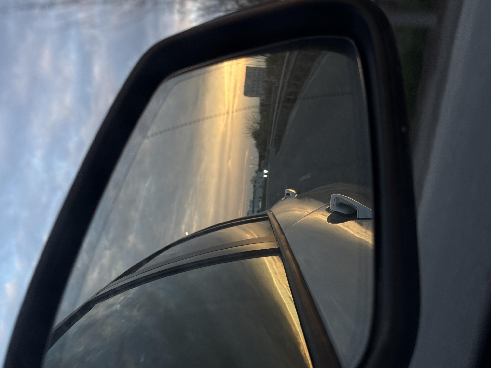Dawn highway reflection captured in car mirror, Tsaratsovo Bulgaria
