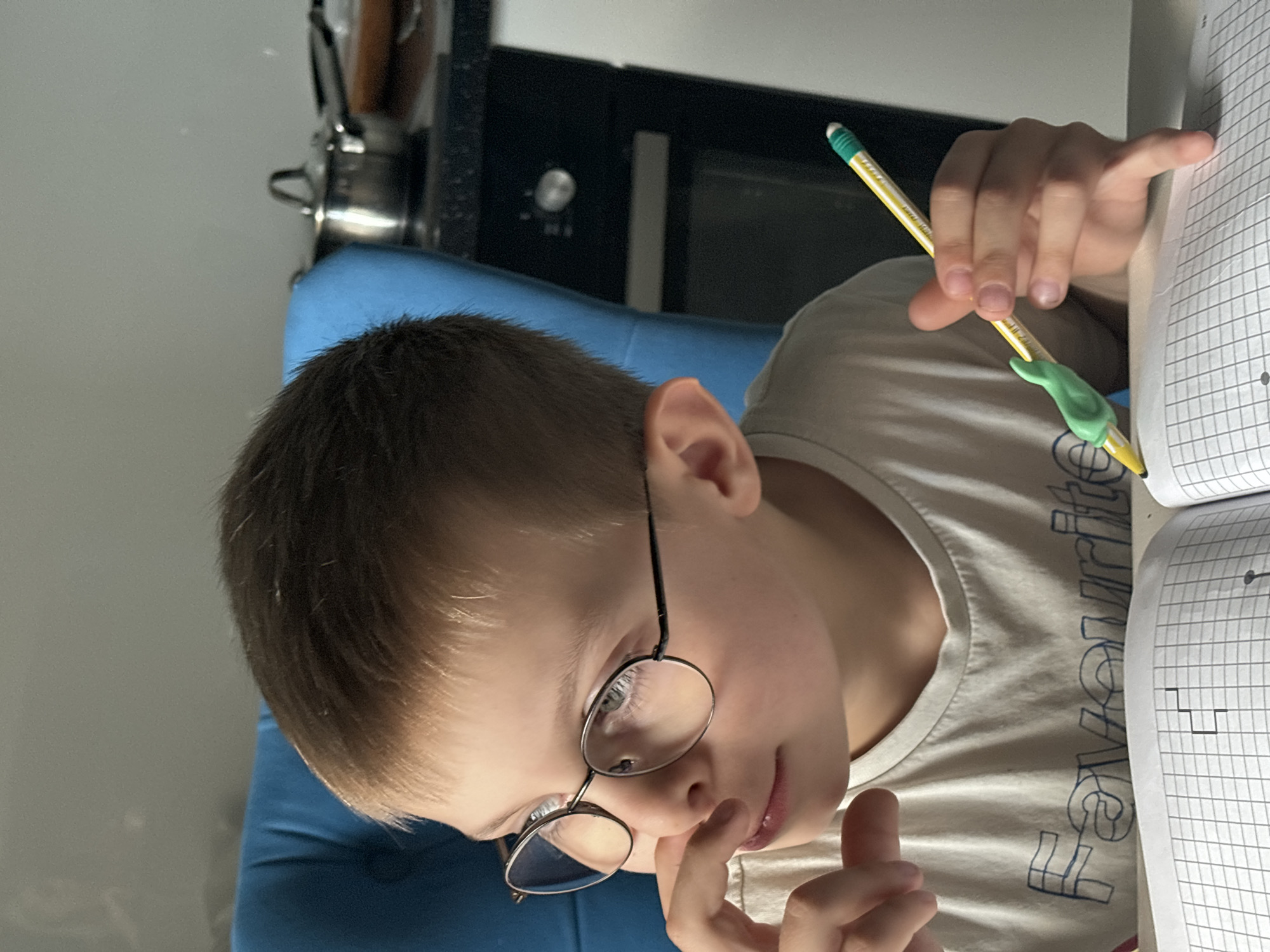 Boy with glasses observed indoors, street traffic captured Russia