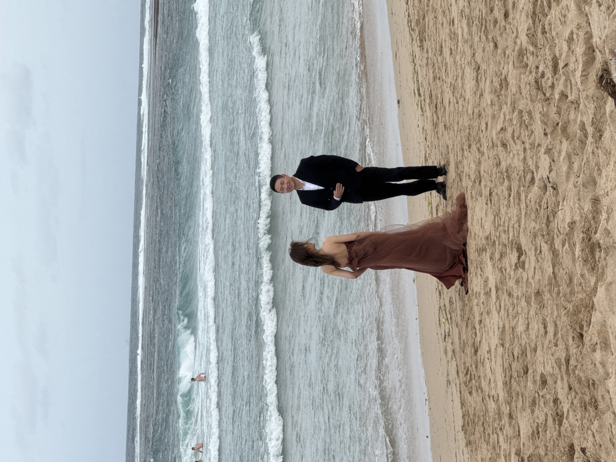 Formal beach photoshoot at the water's edge in Kuta Selatan