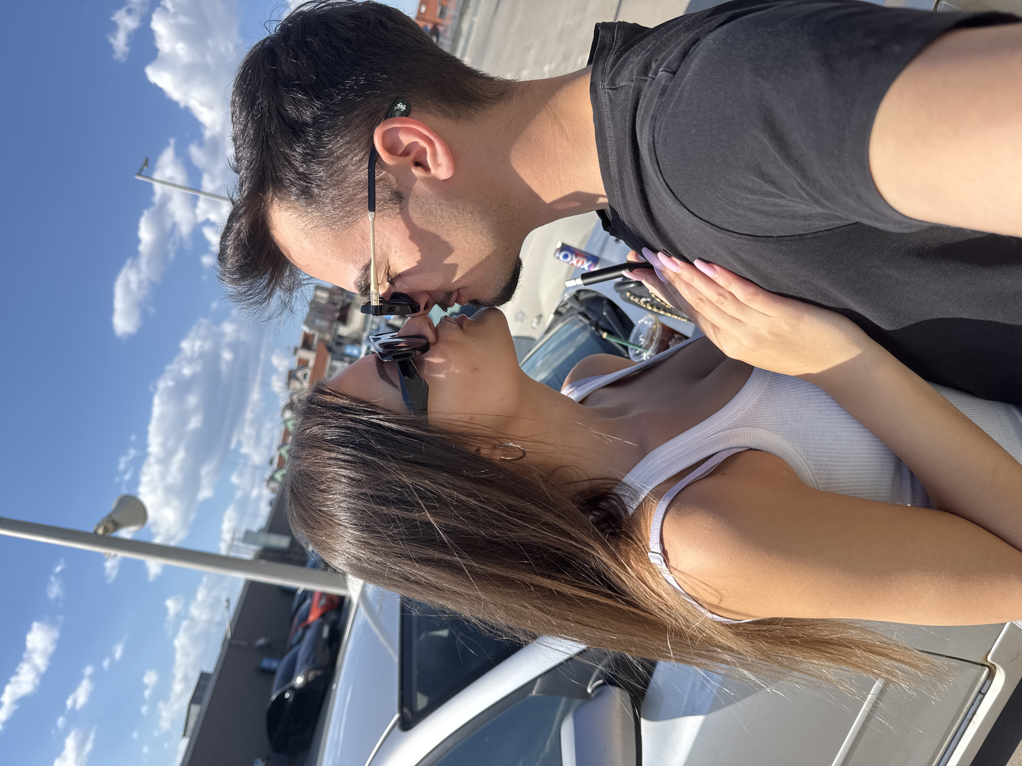 Couple photographed kissing, embracing around Sofia parking lot, escalator