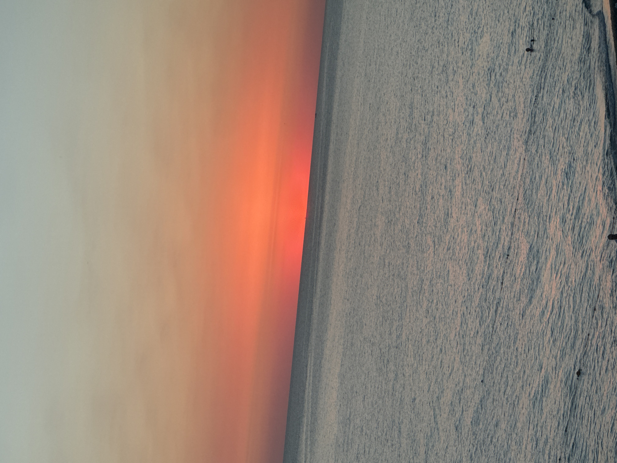 Calm dusk on the Sochi shoreline, sky fading to orange