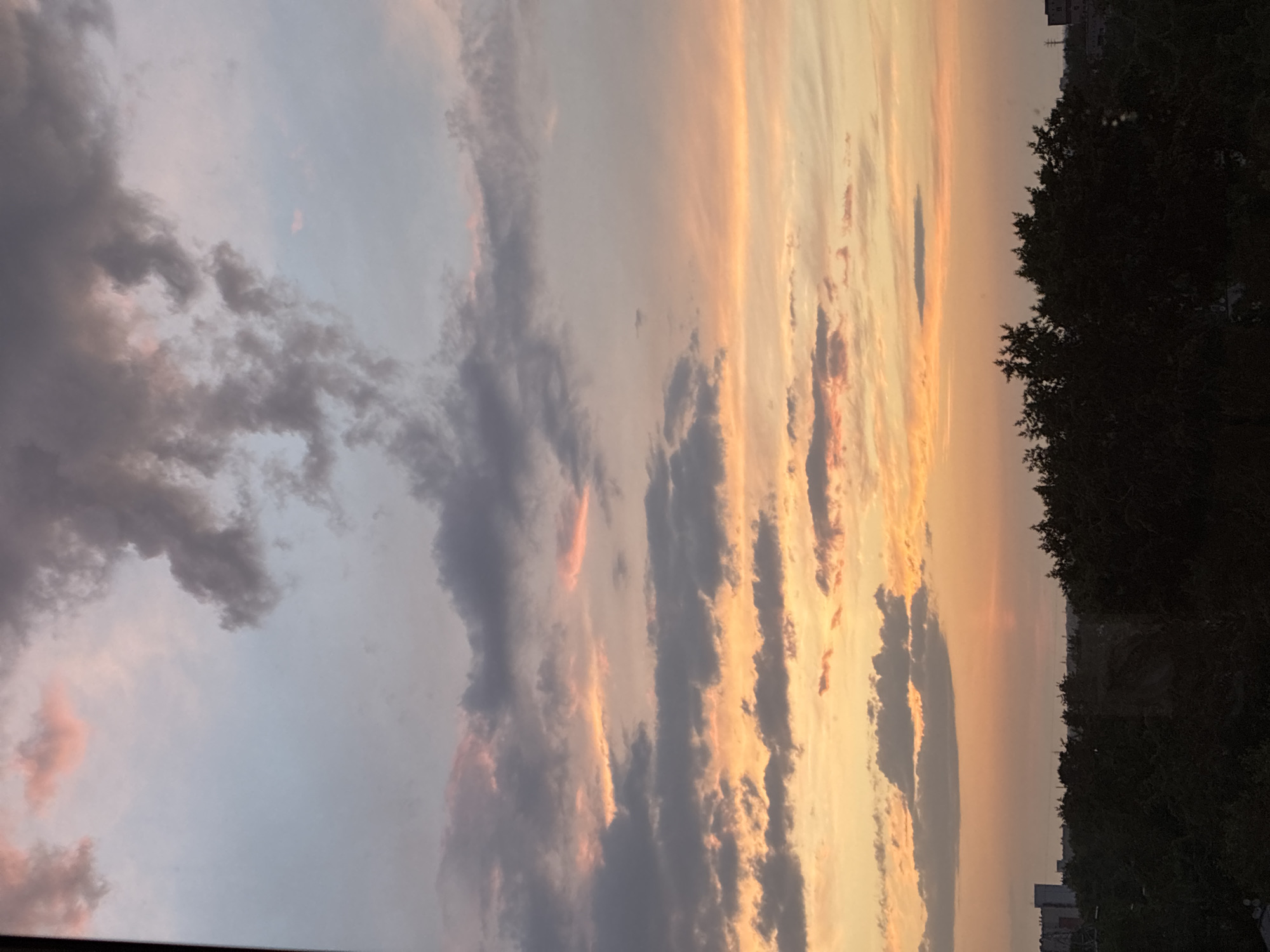 Urban sunset creates vibrant sky display across city skyline