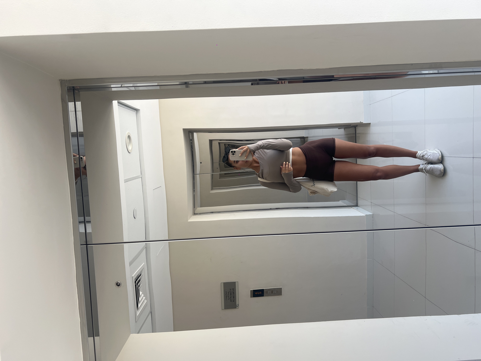 Woman takes mirror selfie in Dubai elevator