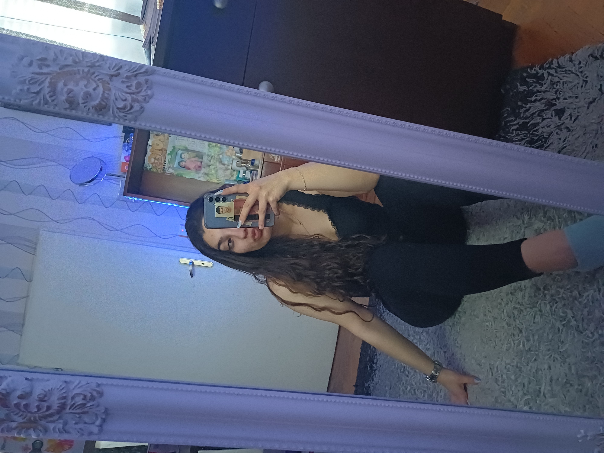 Woman takes mirror selfies at home in Bulgaria