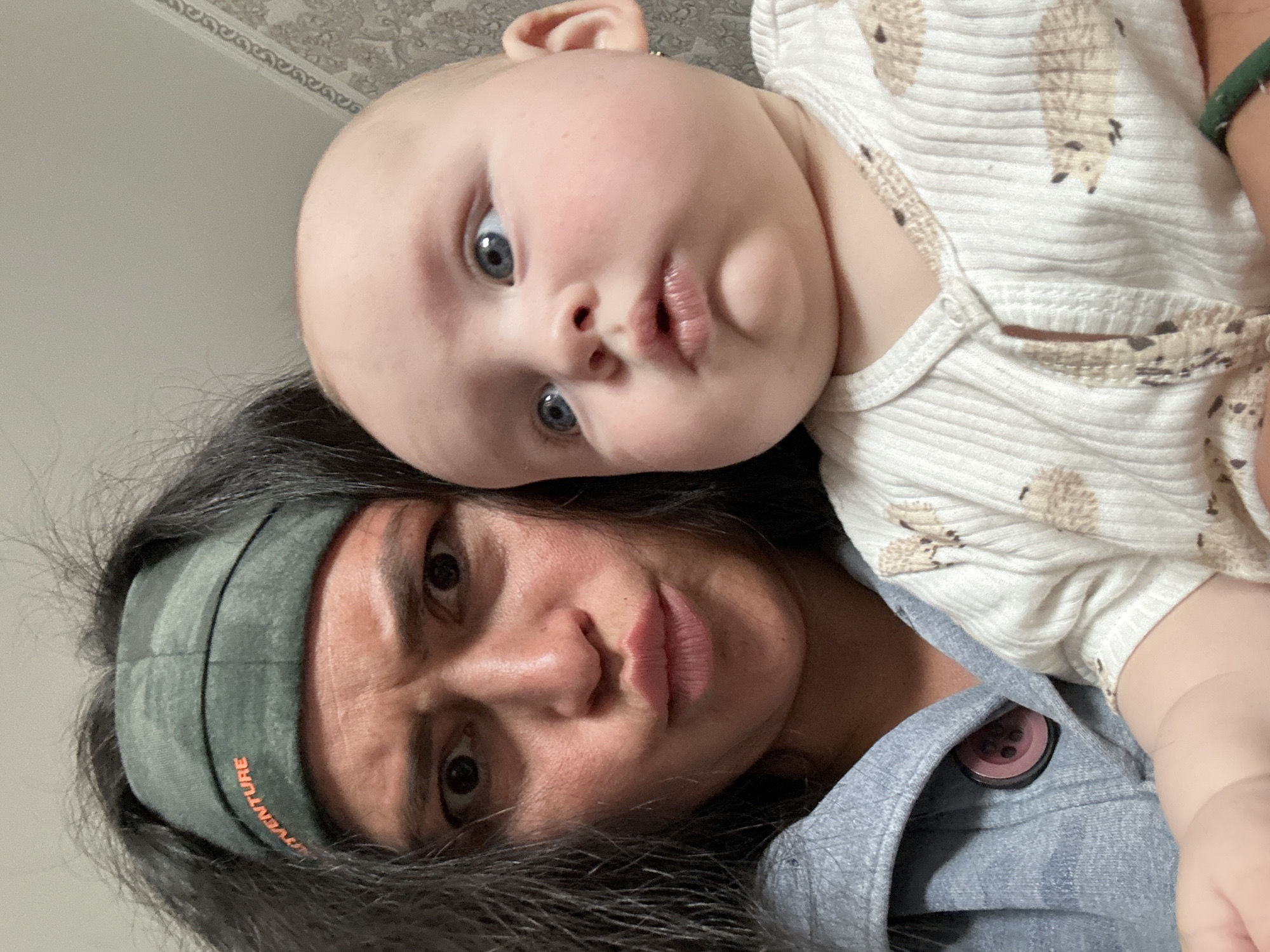 Woman with baby captured in indoor moments in Кемуль, Russia