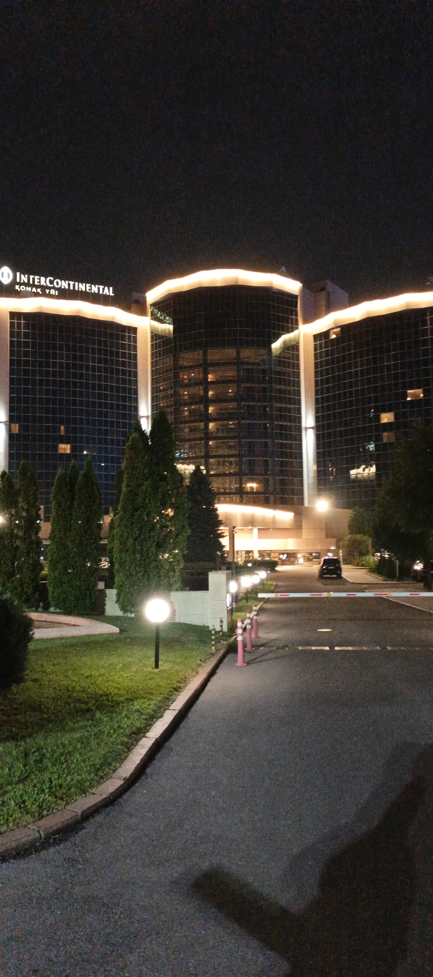 Almaty at night: hotel, park path, and wet streets