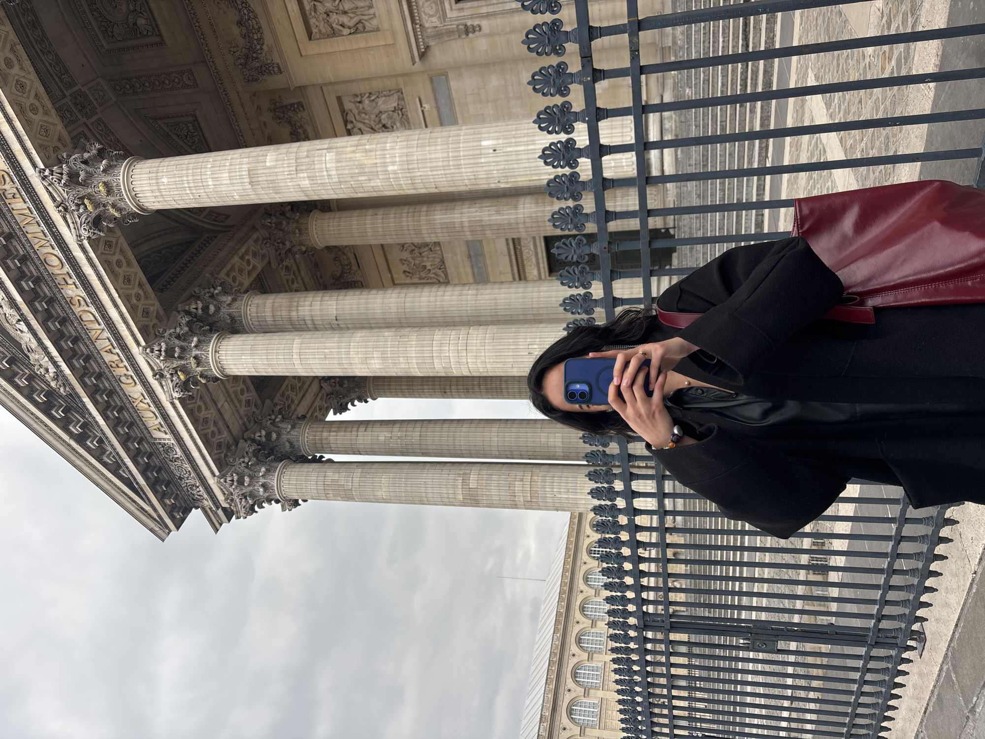 Tourists photograph historic Paris landmarks during evening hours