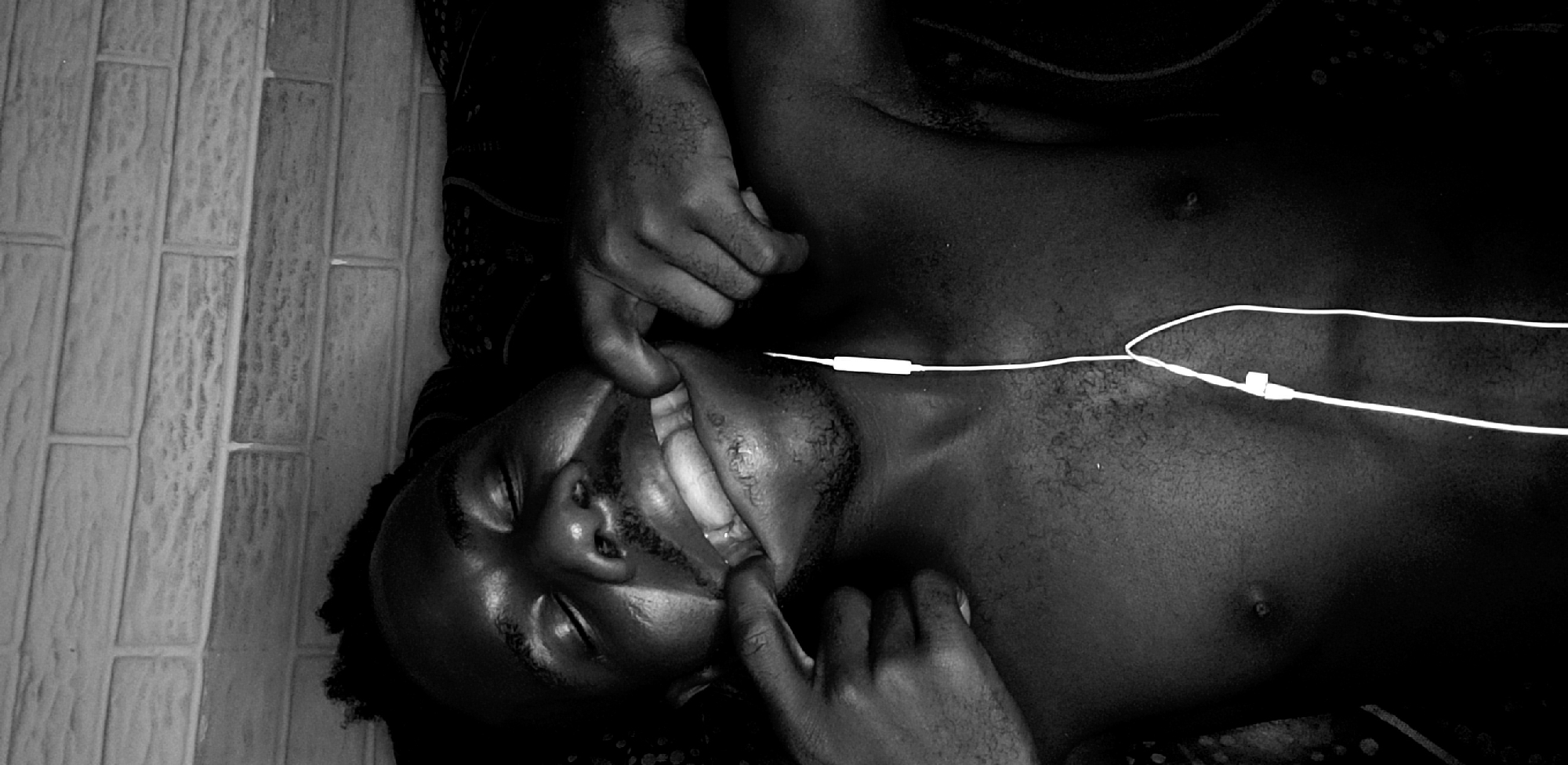 Man photographed lying with headphones in Narayi, Nigeria