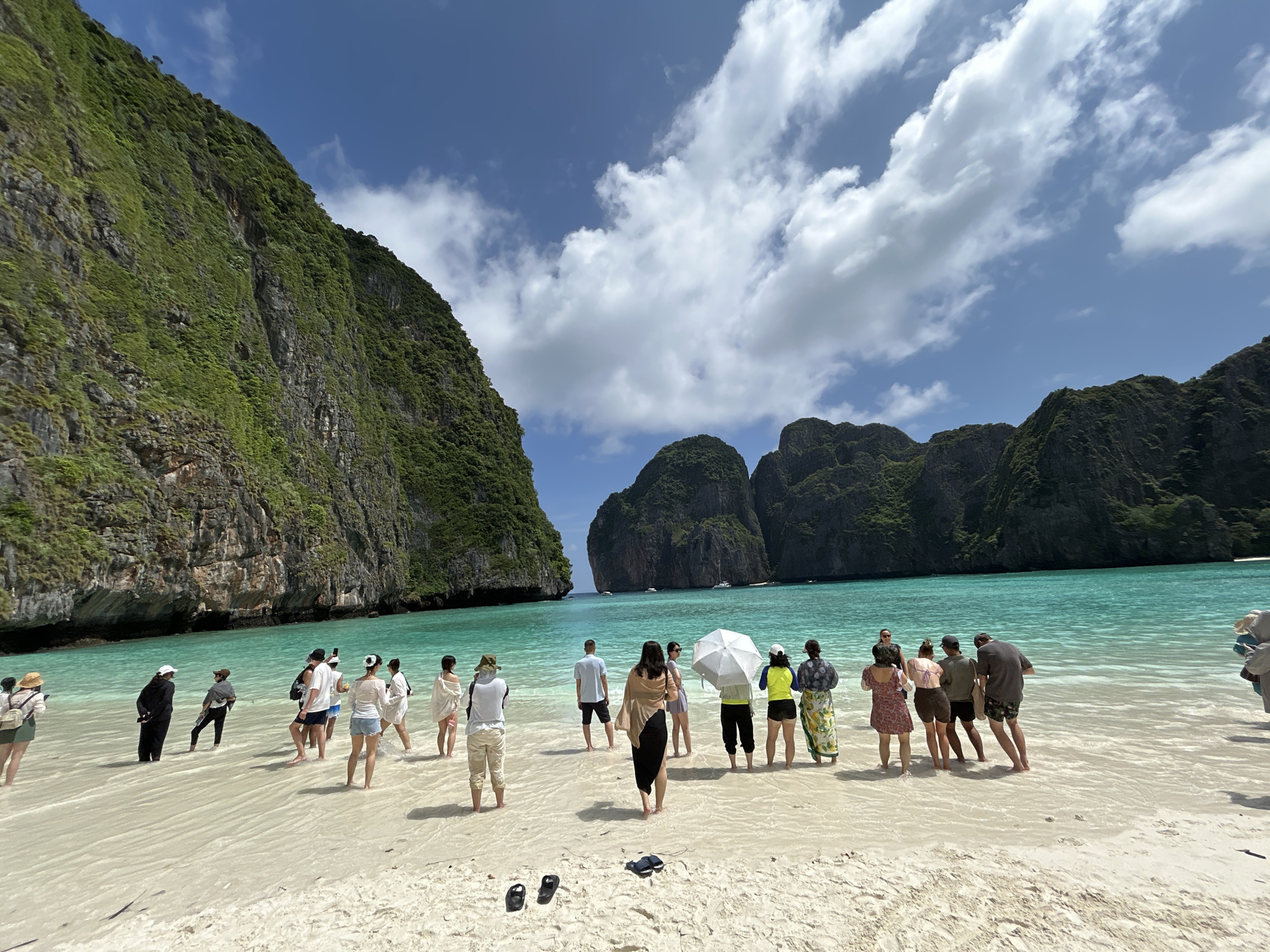 Beachgoers take in Ao Nang's iconic limestone cliffs