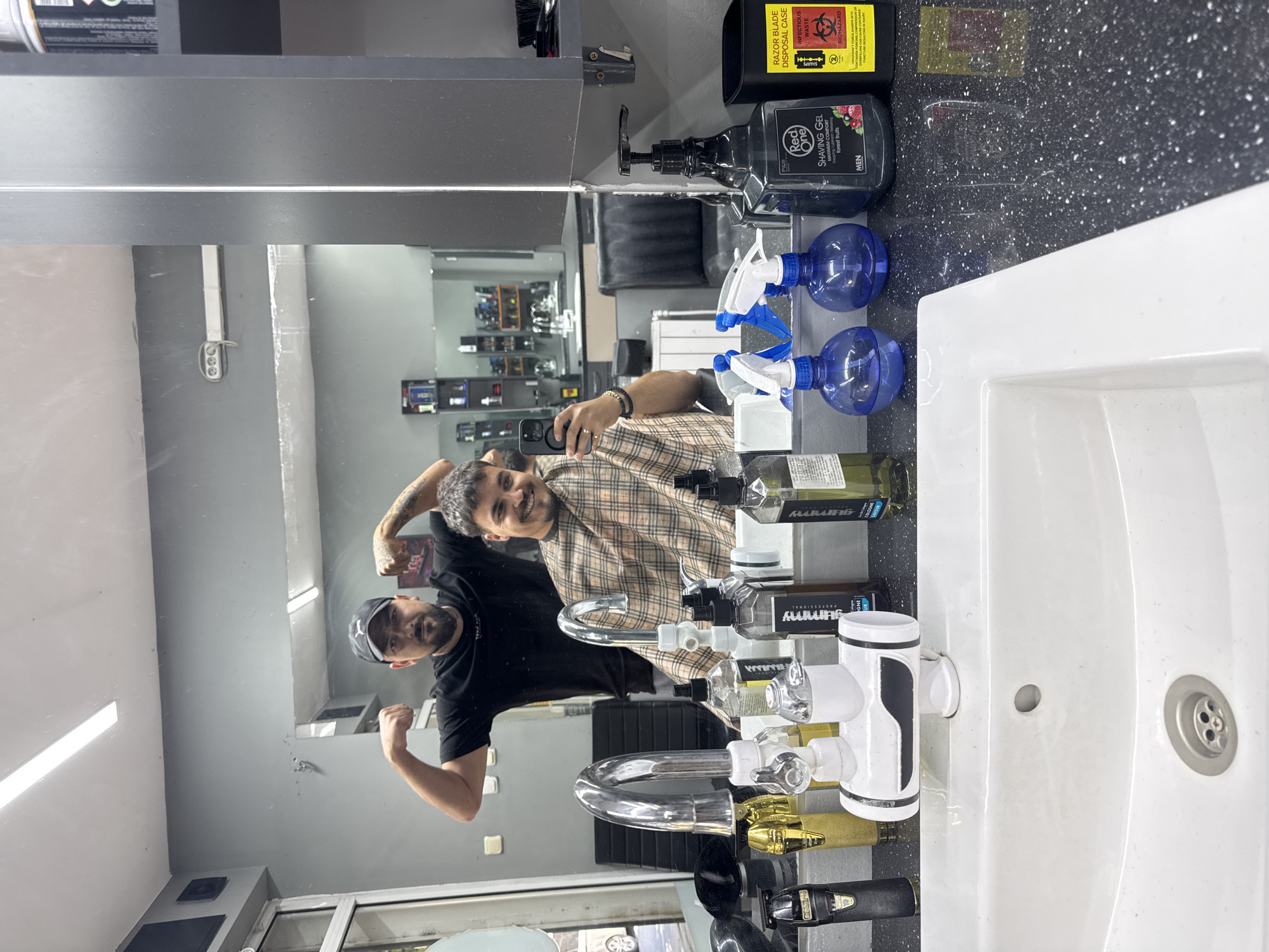 Two men photographed at skull-themed barbershop during morning visit