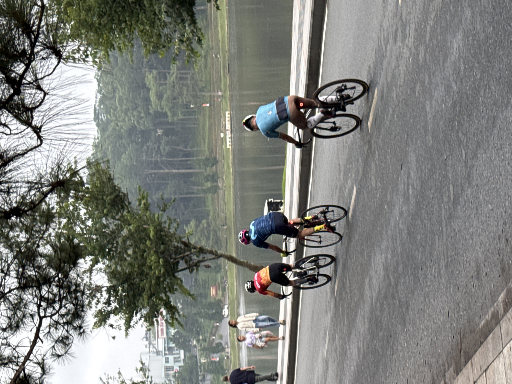 Cyclists and joggers circle Xuân Hương Lake at dusk