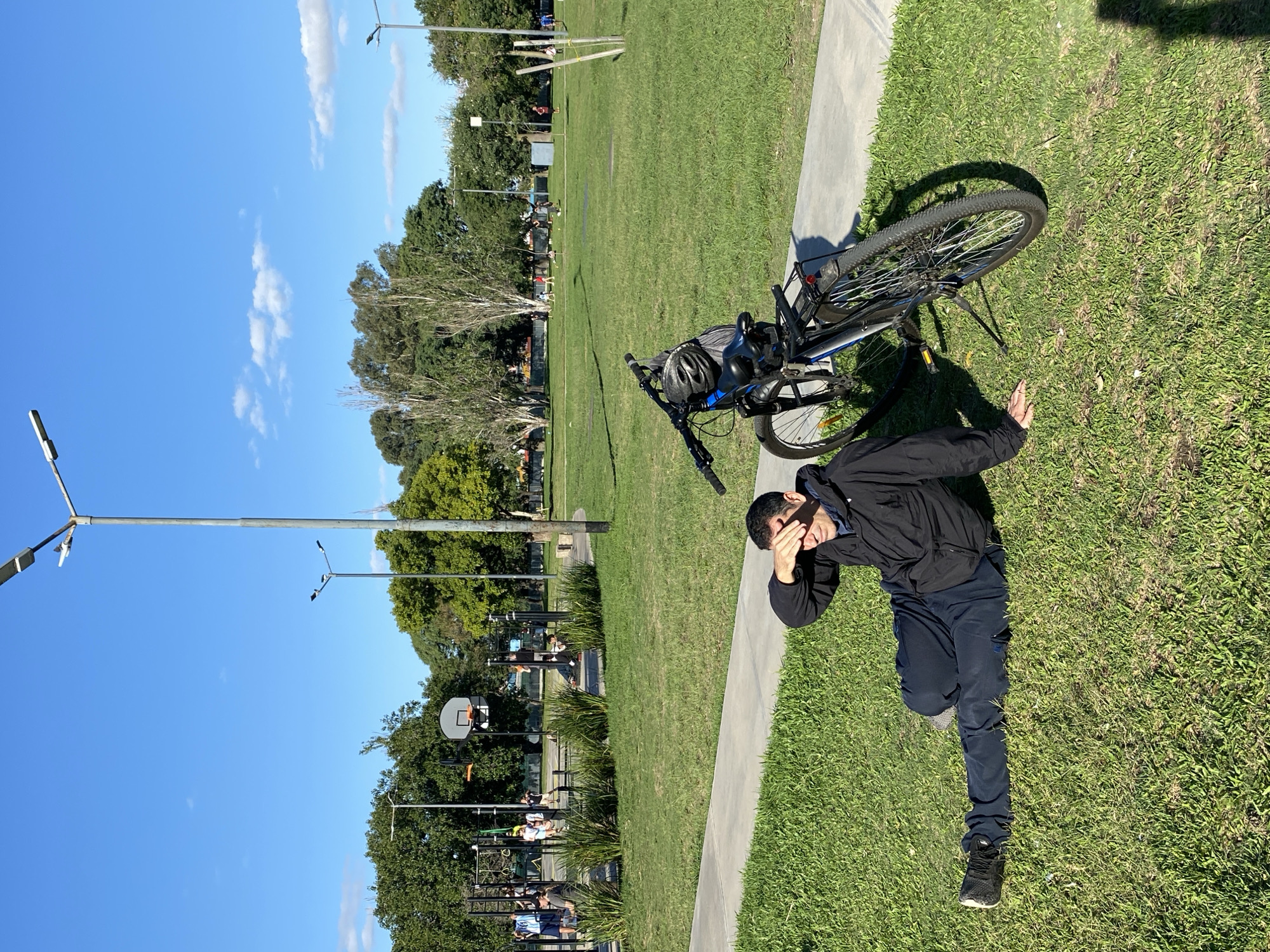 Evening park activity recorded around bronze sculpture in Buenos Aires