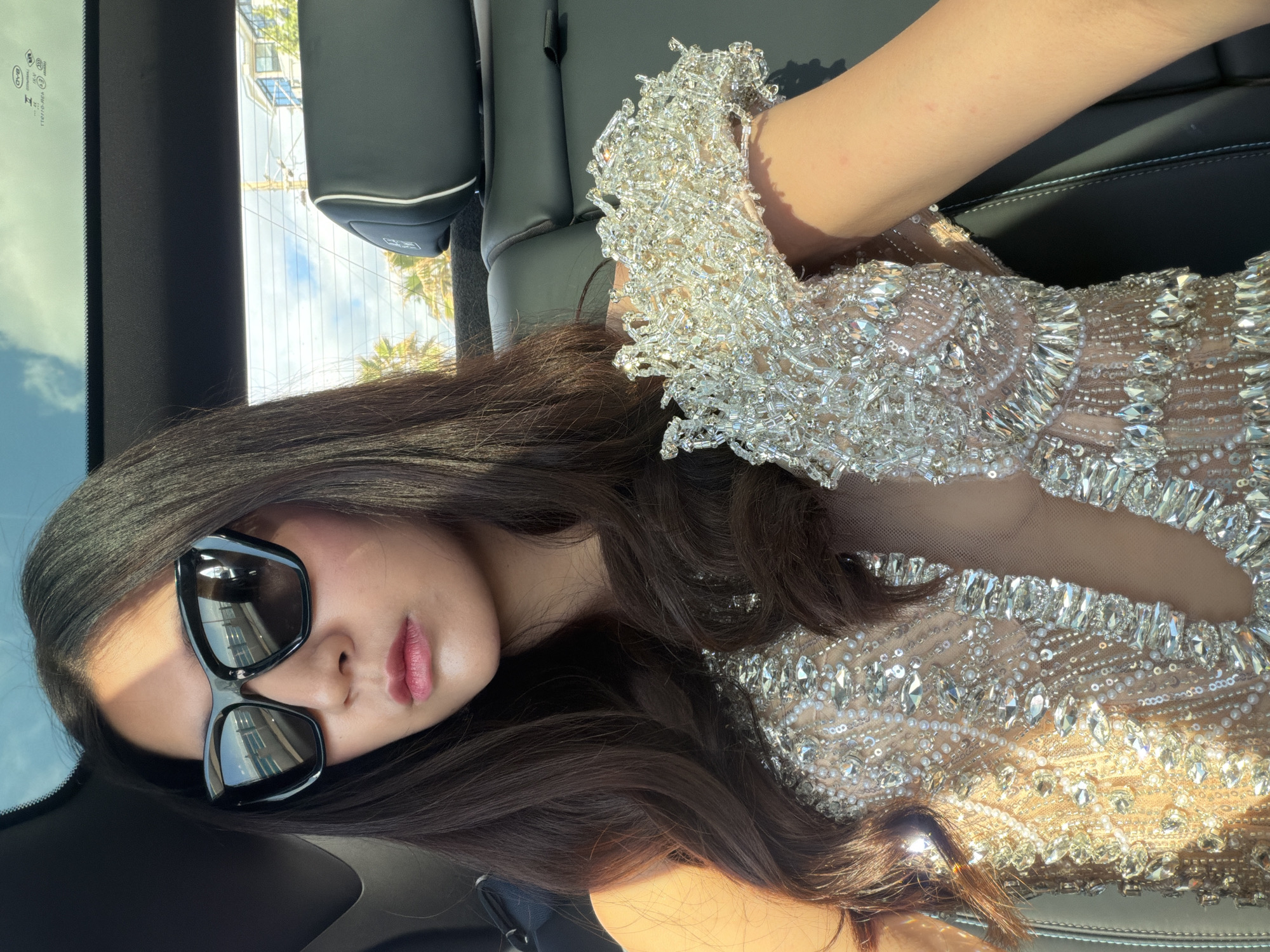 Woman in sequined dress spotted in car in Cannes